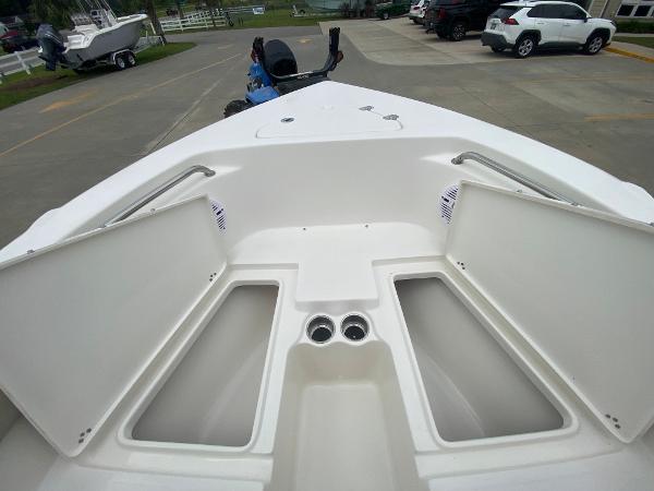 2024 Key West 203 FS boat with open storage compartments on deck.