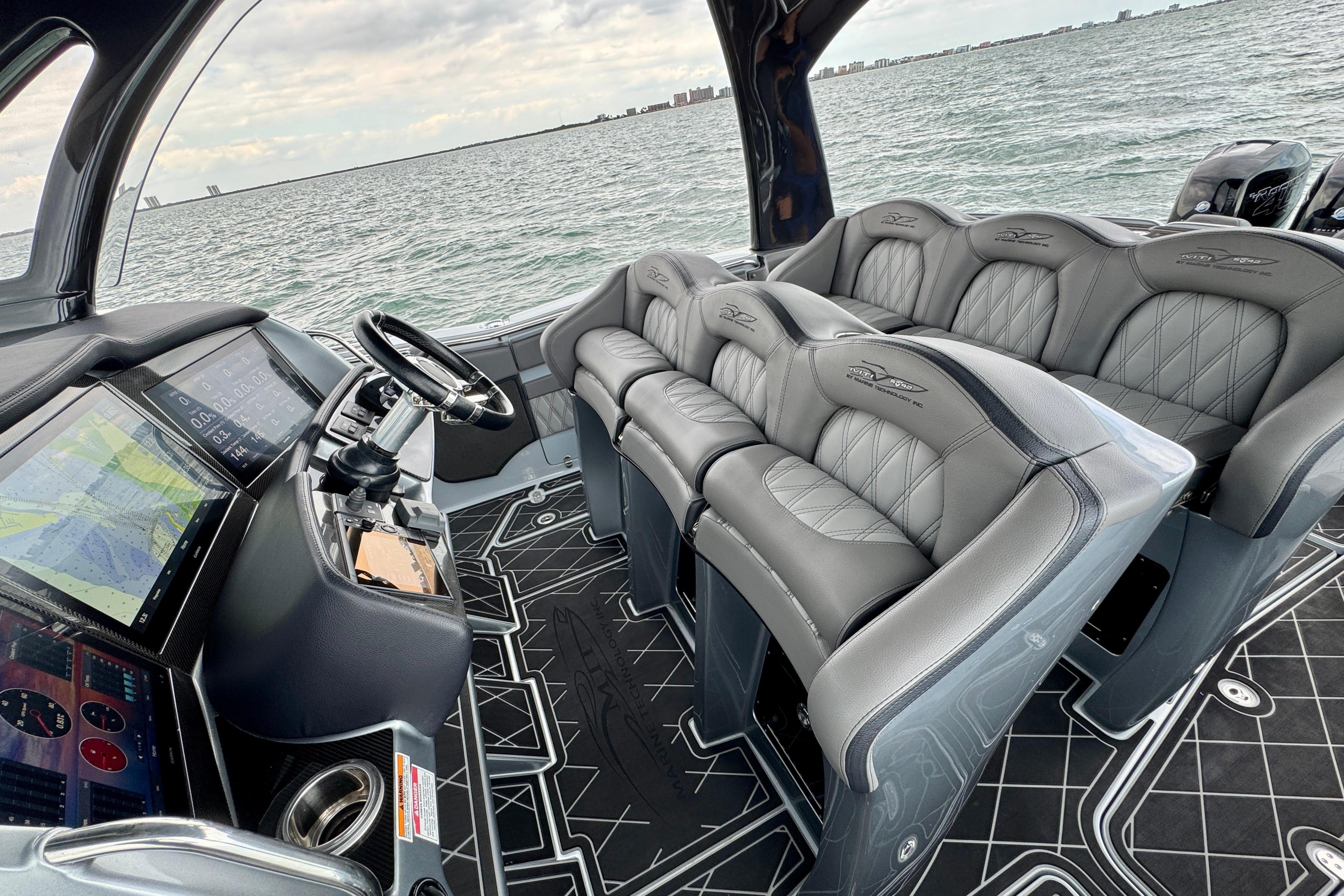 Interior of 2019 MTI V42 boat with luxury seating and advanced navigation system.