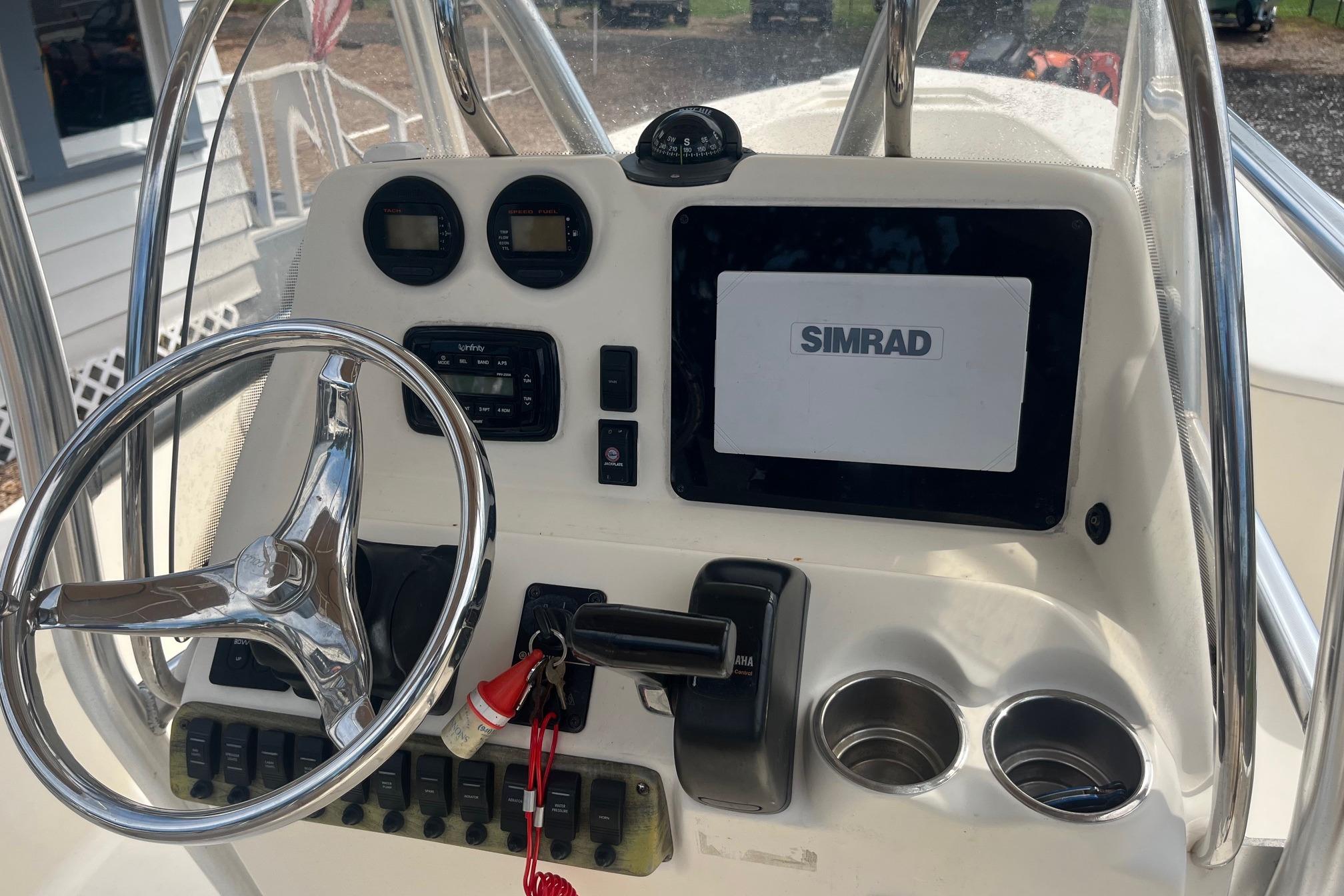 2009 Scout 221 Winyah Bay boat console with Simrad display and steering wheel.