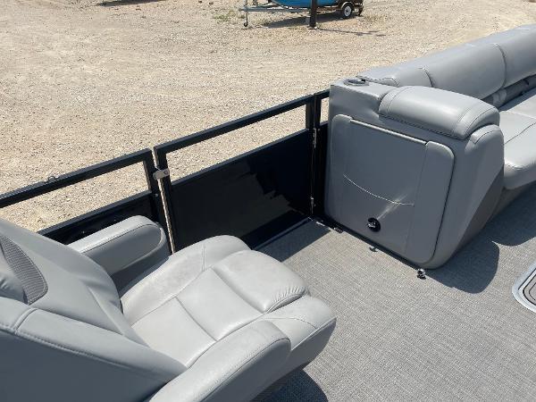 2023 Regency 250 LE3 boat interior with gray seating and railing, on a sandy background.