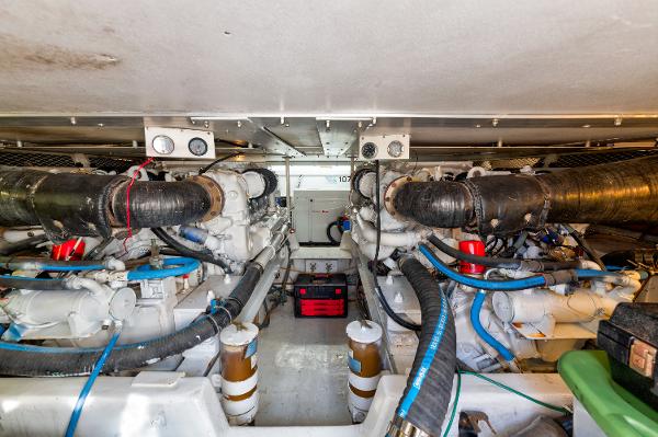 Engine room of a 1999 Viking 47 Convertible yacht, featuring dual engines and various components.