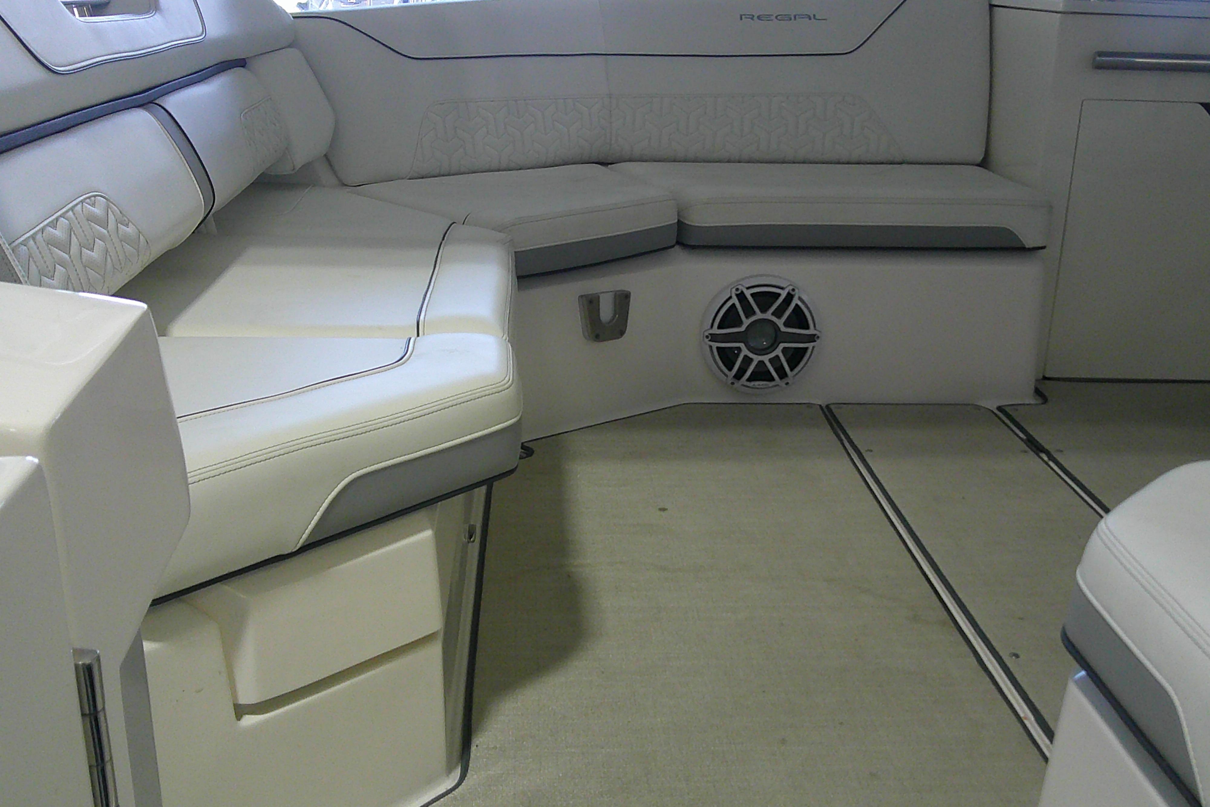 Luxurious interior seating of 2023 Regal LX36 boat with elegant upholstery and speaker system.