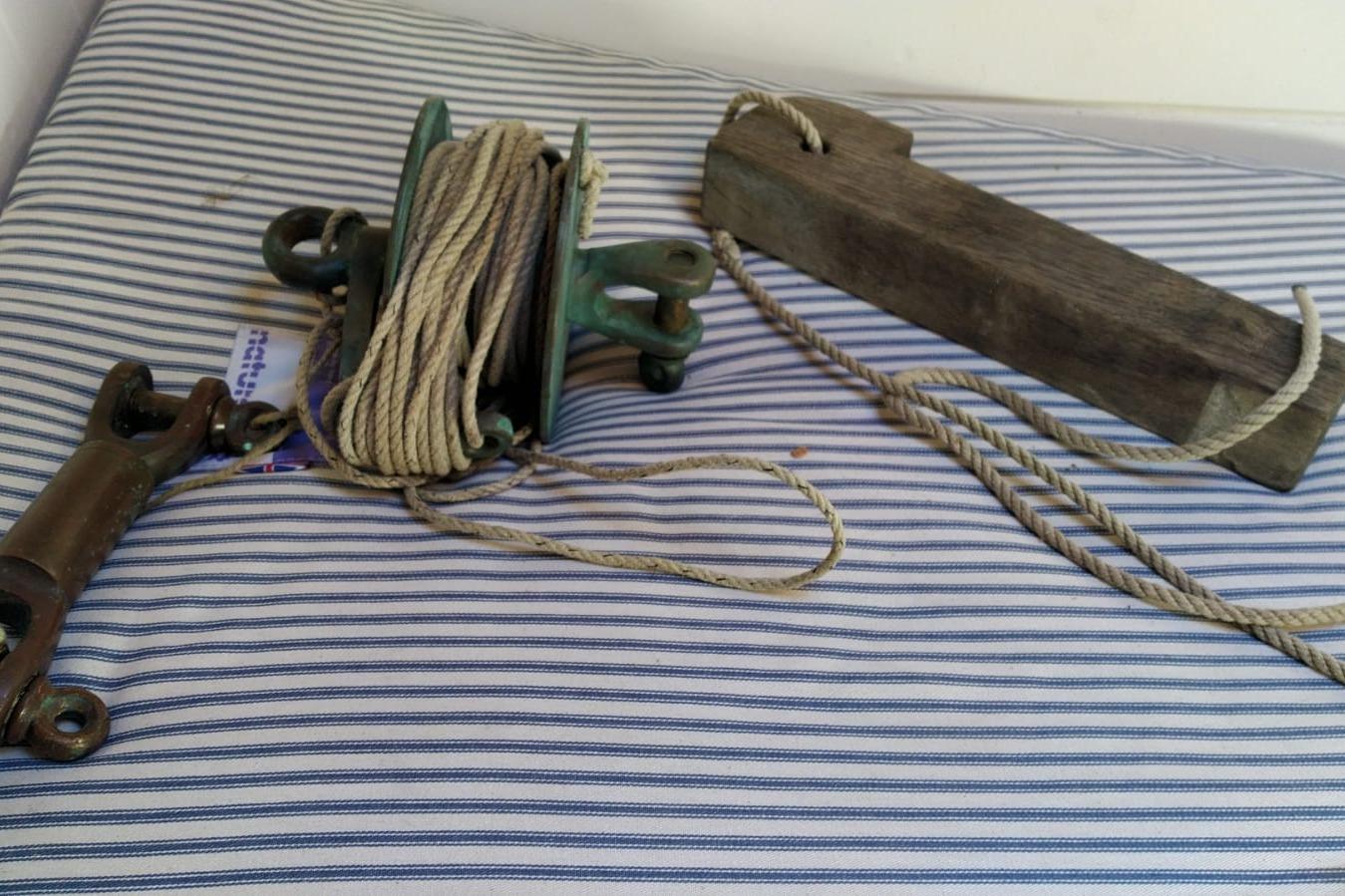 Vintage nautical equipment with ropes on striped fabric, Custom Mayflower 50, 2012.