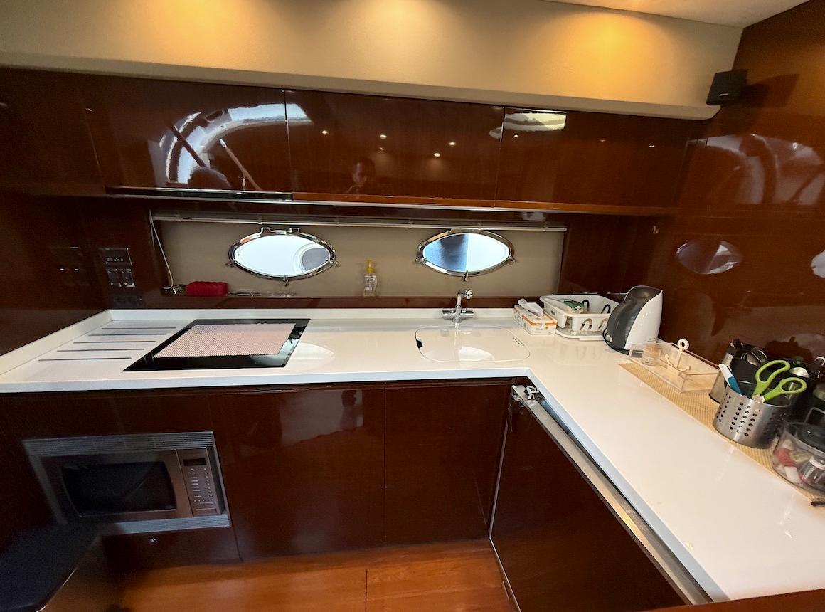 Luxurious kitchen interior of 2009 Princess V53 yacht with modern appliances and sleek design.