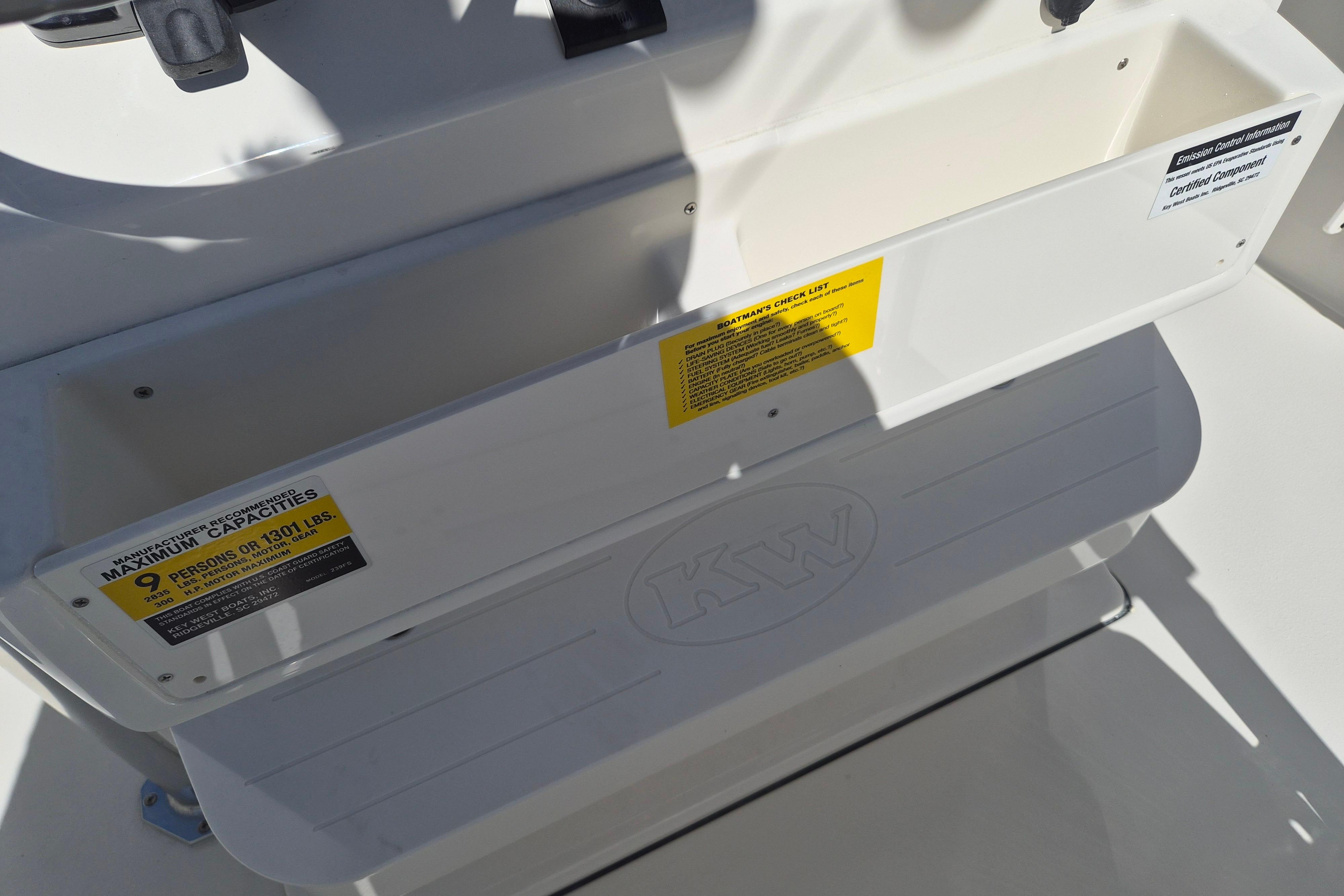 2026 Key West 239 FS boat interior with capacity label for nine persons or 1301 lbs.