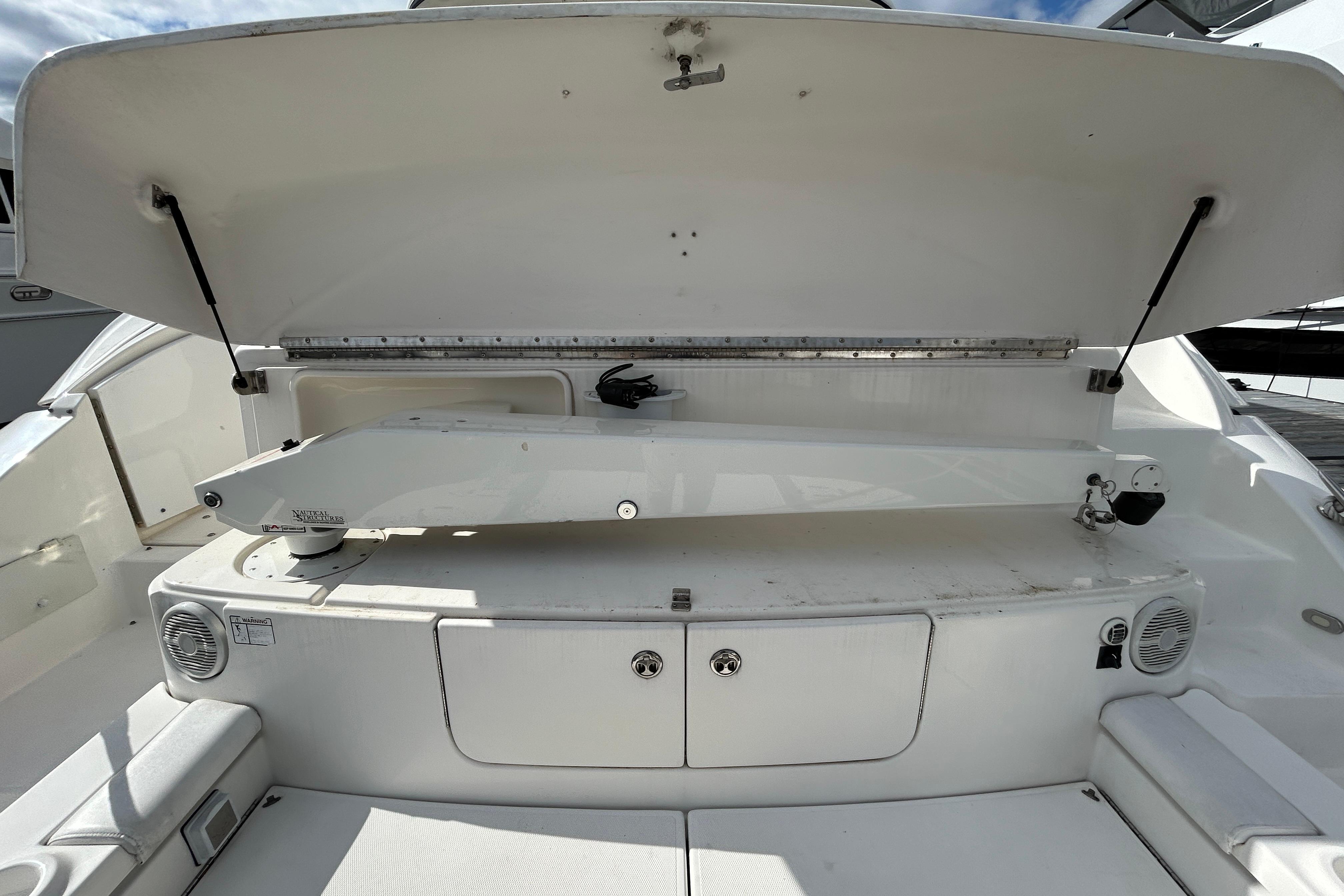 2003 Cruisers Yachts 540 Express boat interior with open storage compartment.