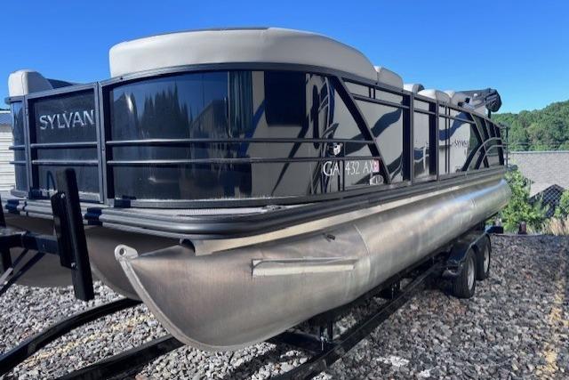 2022 Sylvan L3 DLZ Bar pontoon boat on trailer, sleek design, outdoor setting.