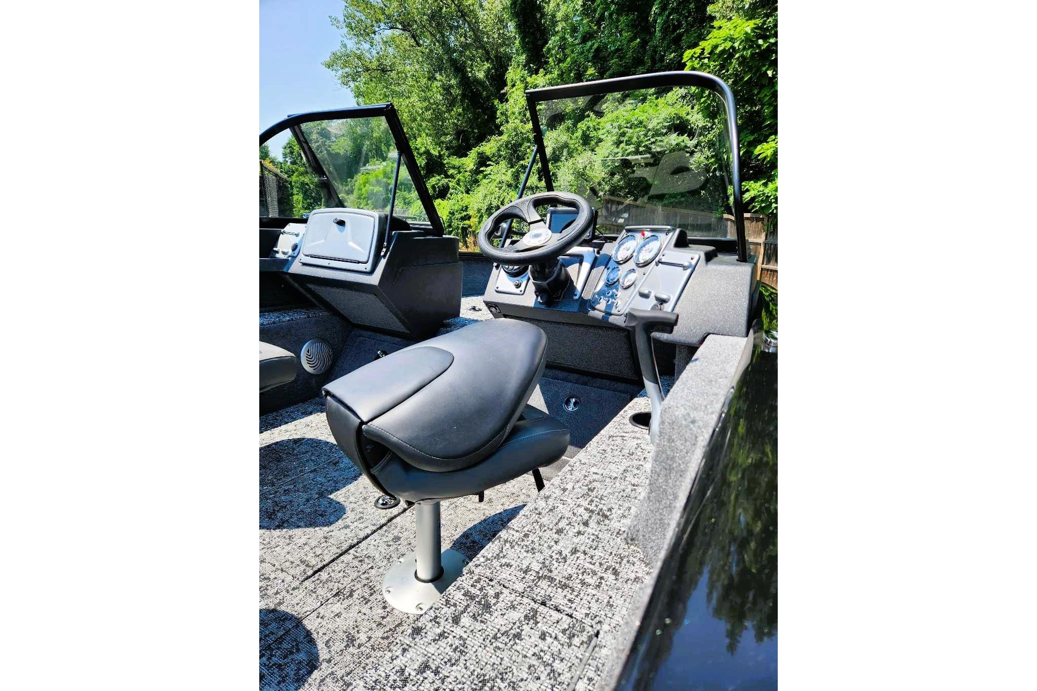 2026 Tracker Pro Guide V-175 Combo boat interior with steering wheel and seating.