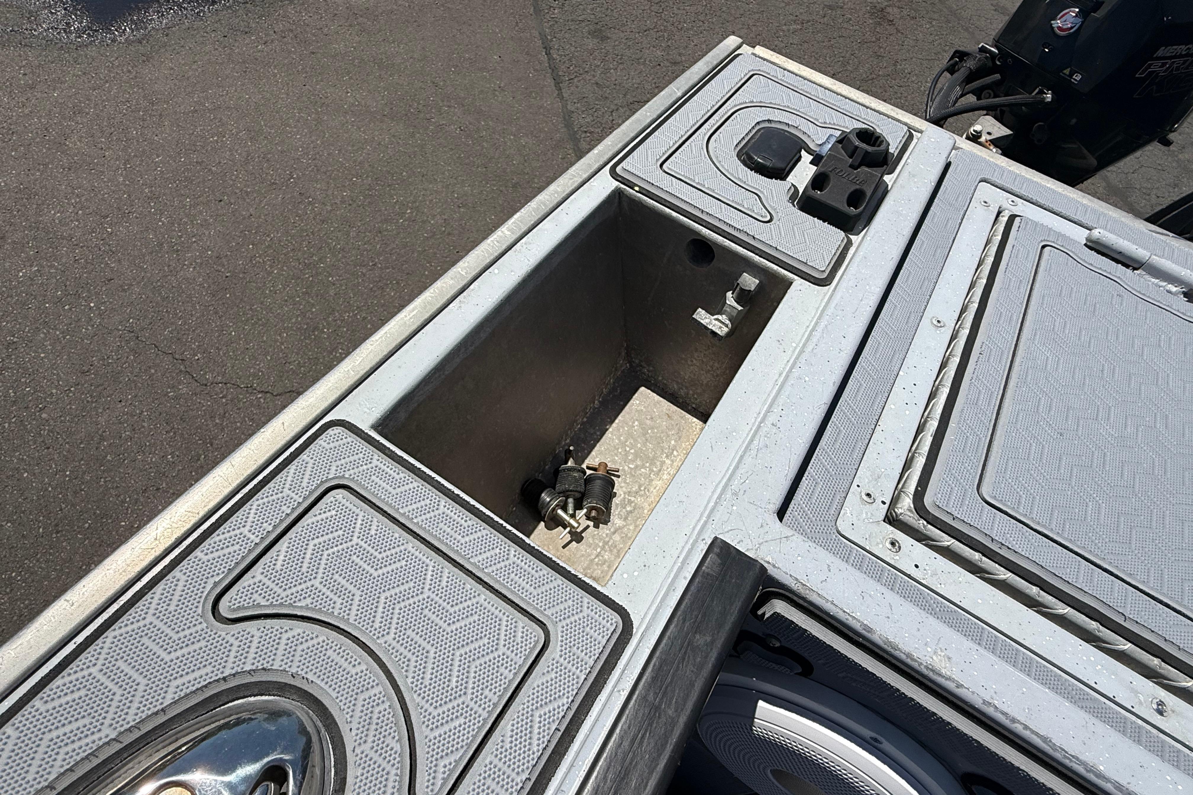 2015 Alumaweld Pacific XD 28 boat deck with storage compartments and motor.