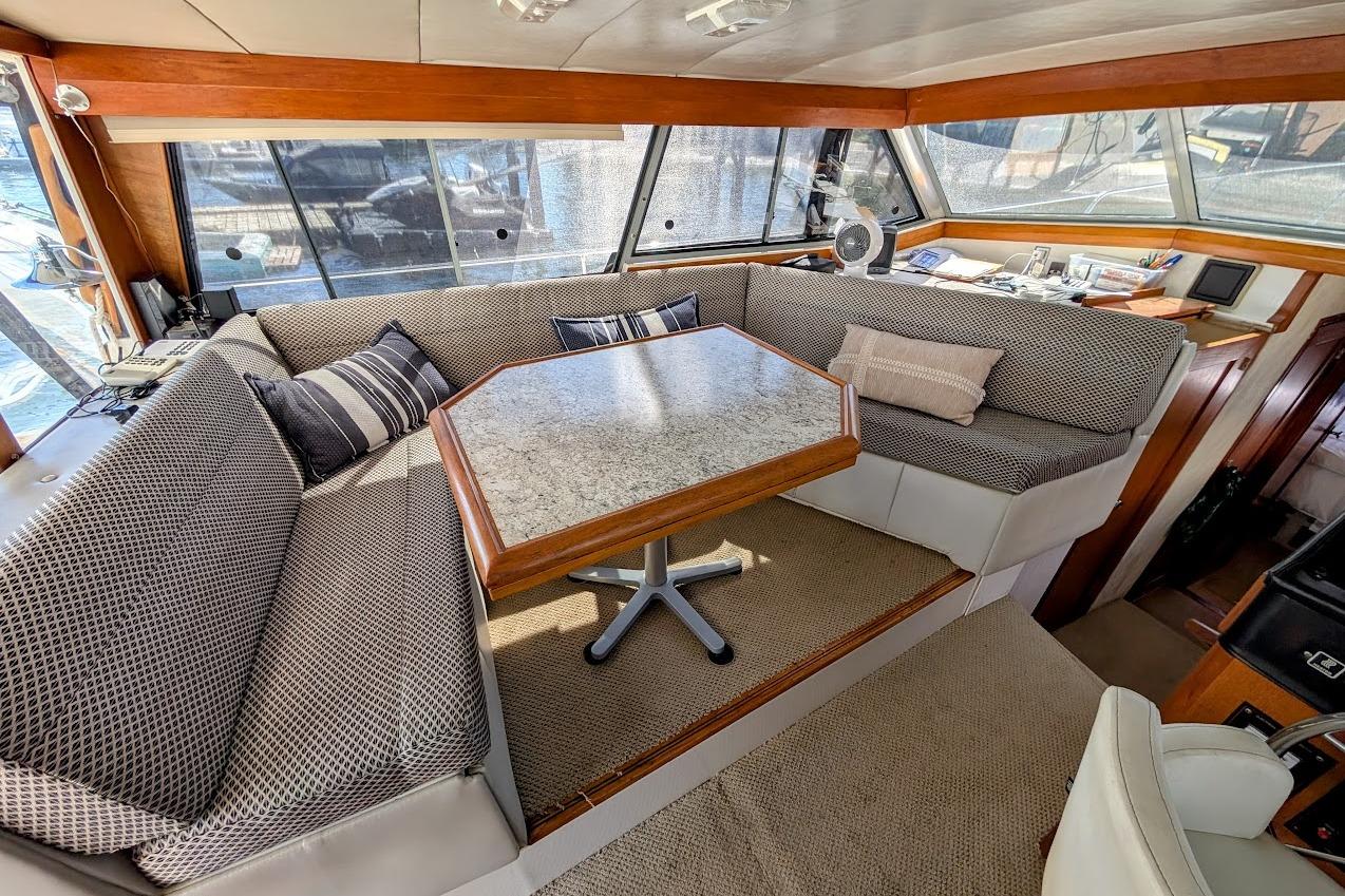 Interior of 1989 Bayliner 3888 Motoryacht with cozy seating and table.