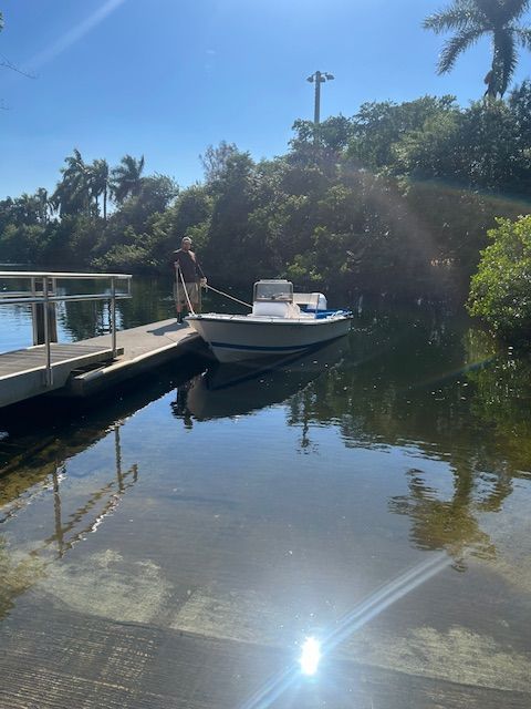 1994 Aquasport Osprey boat docked on a sunny day.