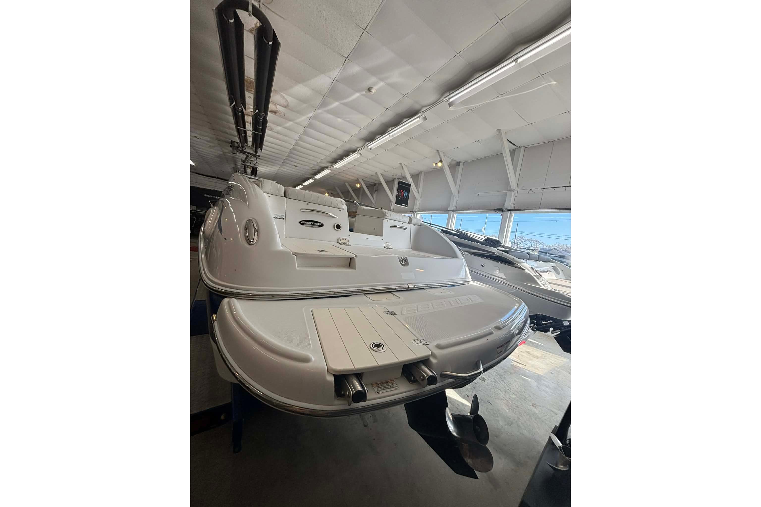 1999 Tide Craft Trophy Angler boat displayed indoors, showcasing rear deck and motor.