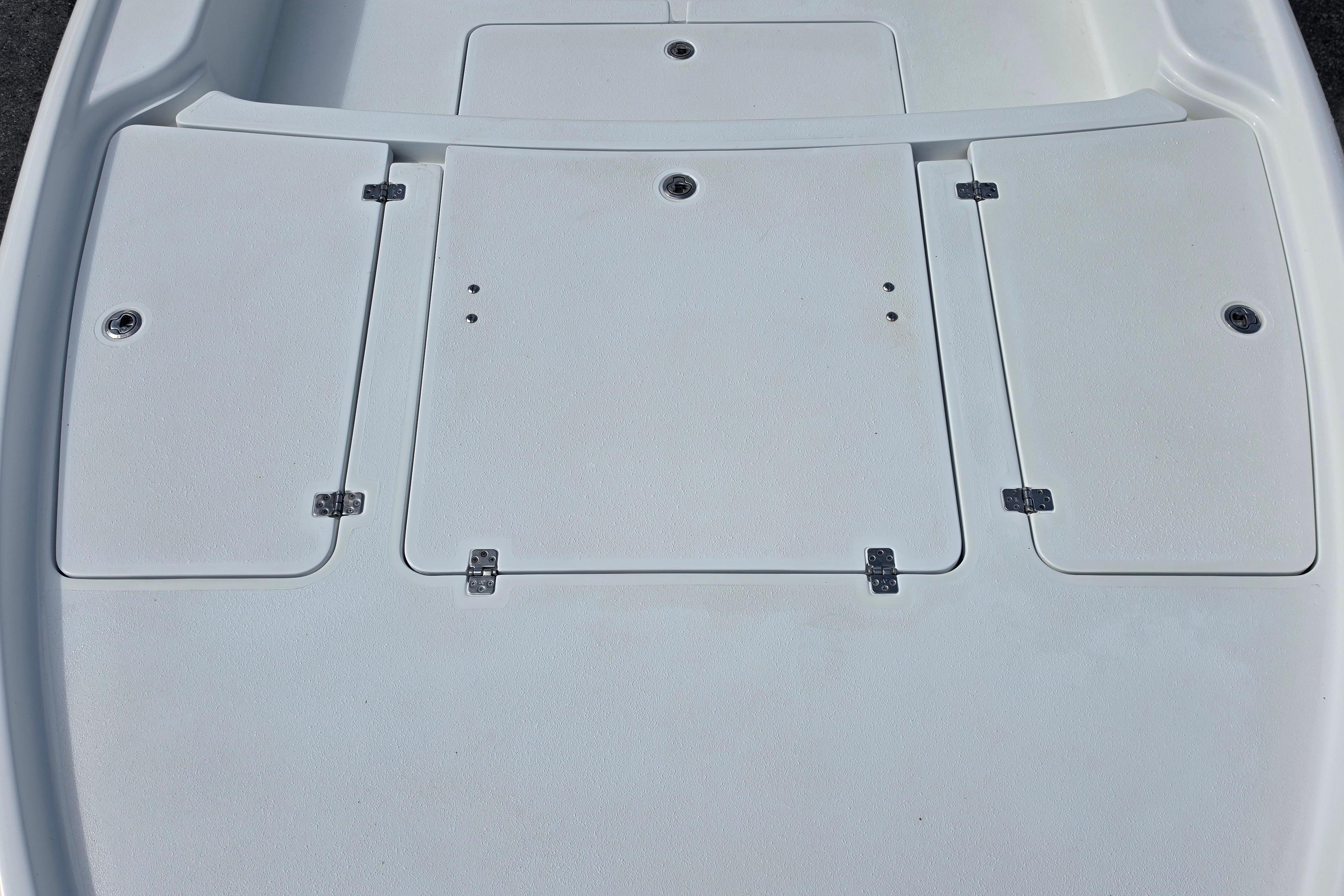 2026 Yellowfin 24 Bay CE boat deck with storage compartments, featuring a sleek white finish.