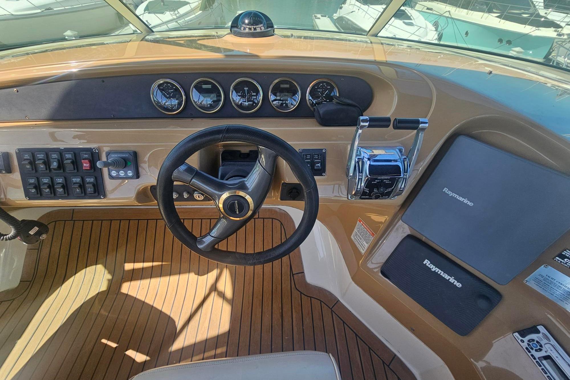 Helm of 2002 Carver 450 Voyager Pilothouse with steering wheel and control panels.