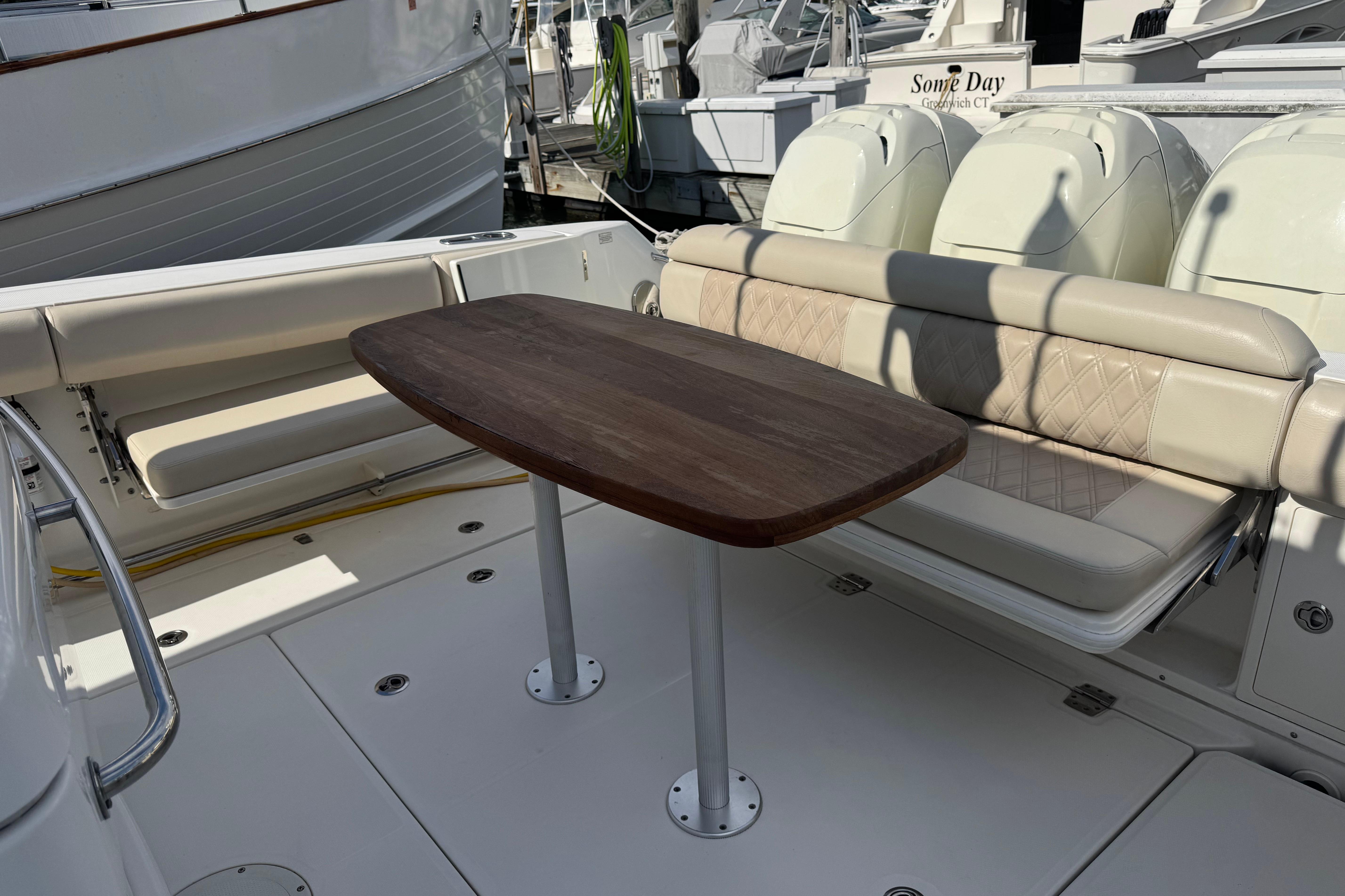 2017 Boston Whaler 370 Outrage boat interior with seating and wooden table.