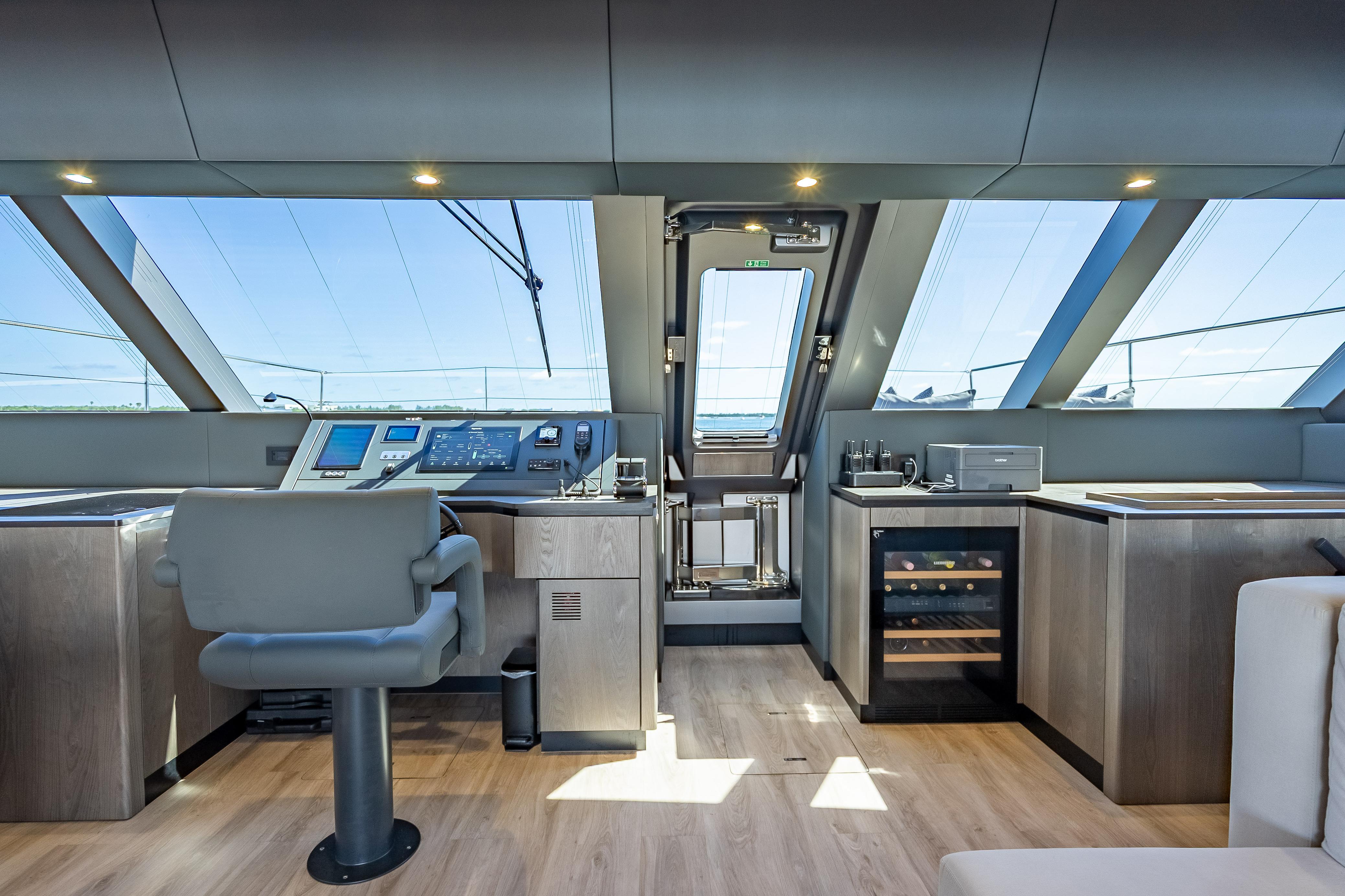 Luxurious interior of 2026 Sunreef 60 Power yacht with modern helm and panoramic windows.