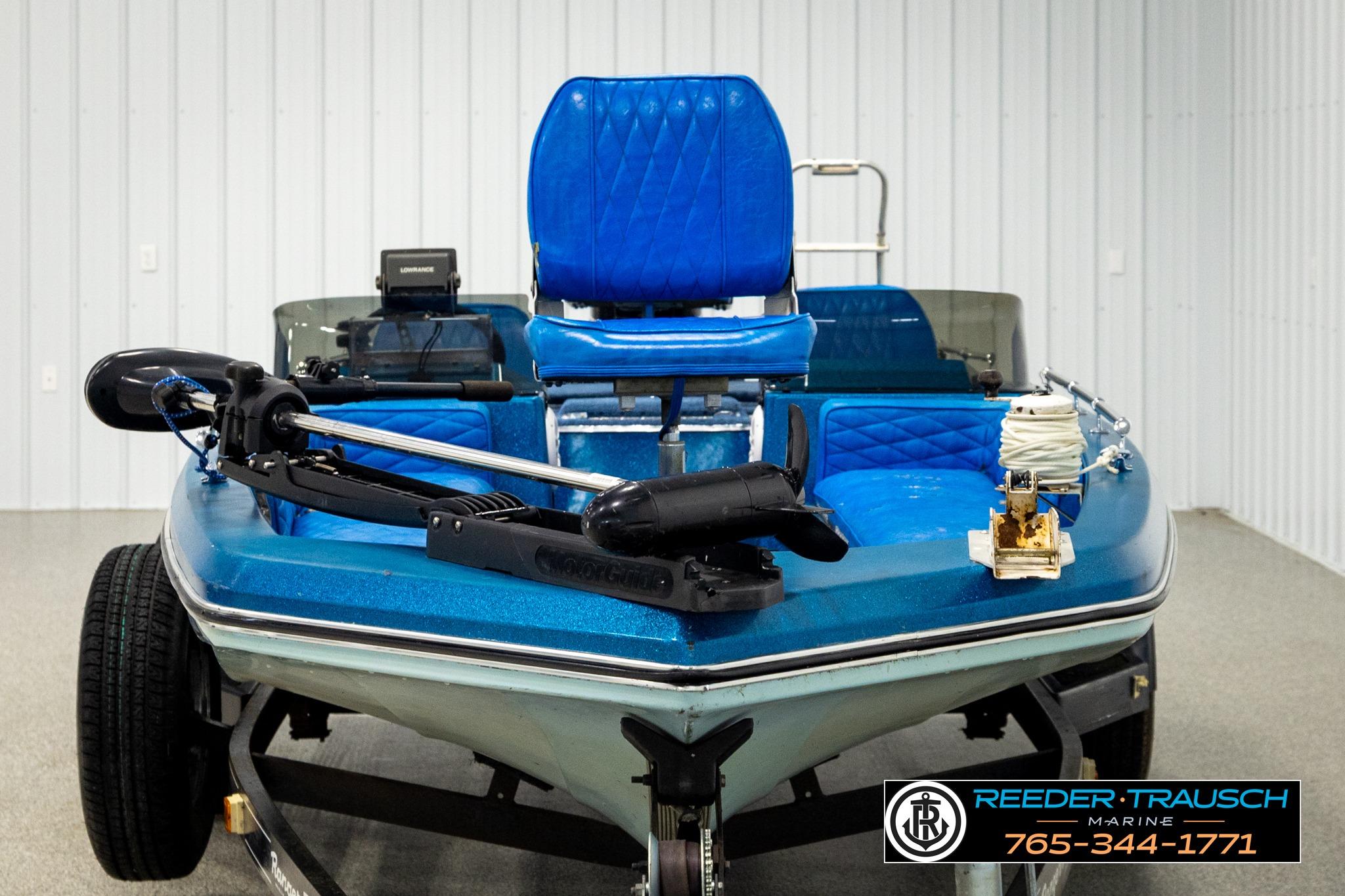 1980 Ranger 175 VS boat with blue seats and fishing equipment in a showroom.