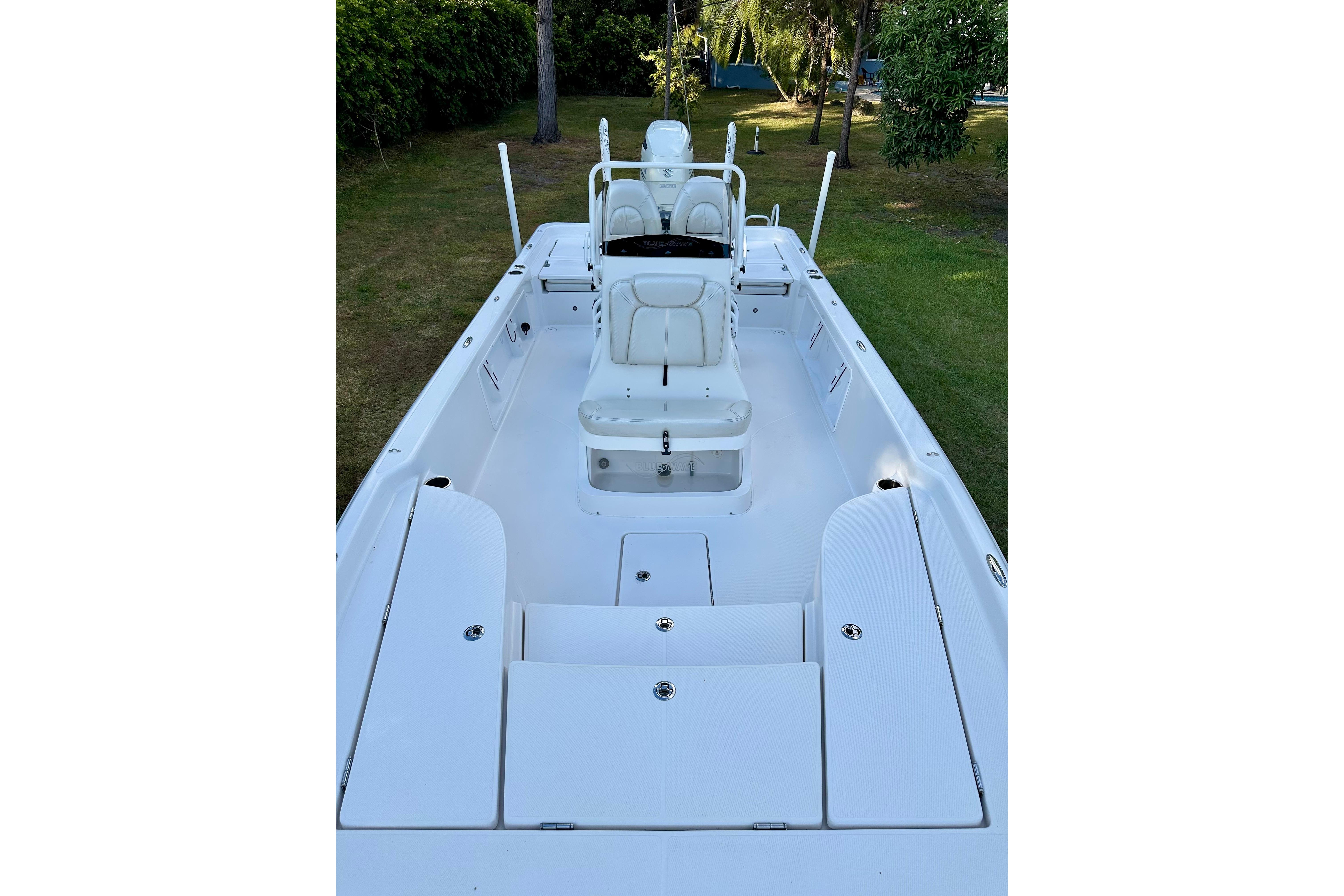 2017 Blue Wave 2400 PureBay boat interior with white seating and storage compartments.
