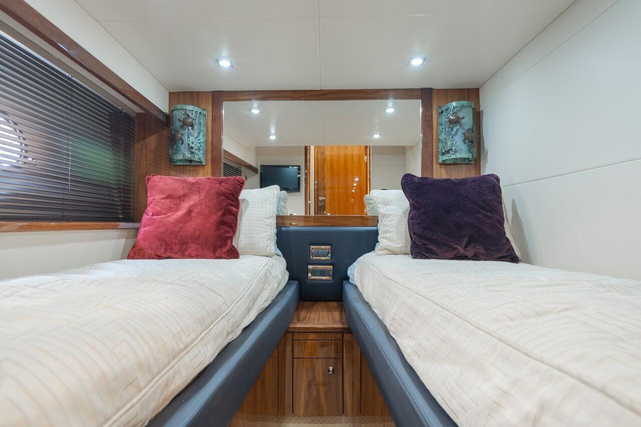 Luxurious twin cabin interior of 2010 Sunseeker Manhattan 60 yacht with plush bedding.