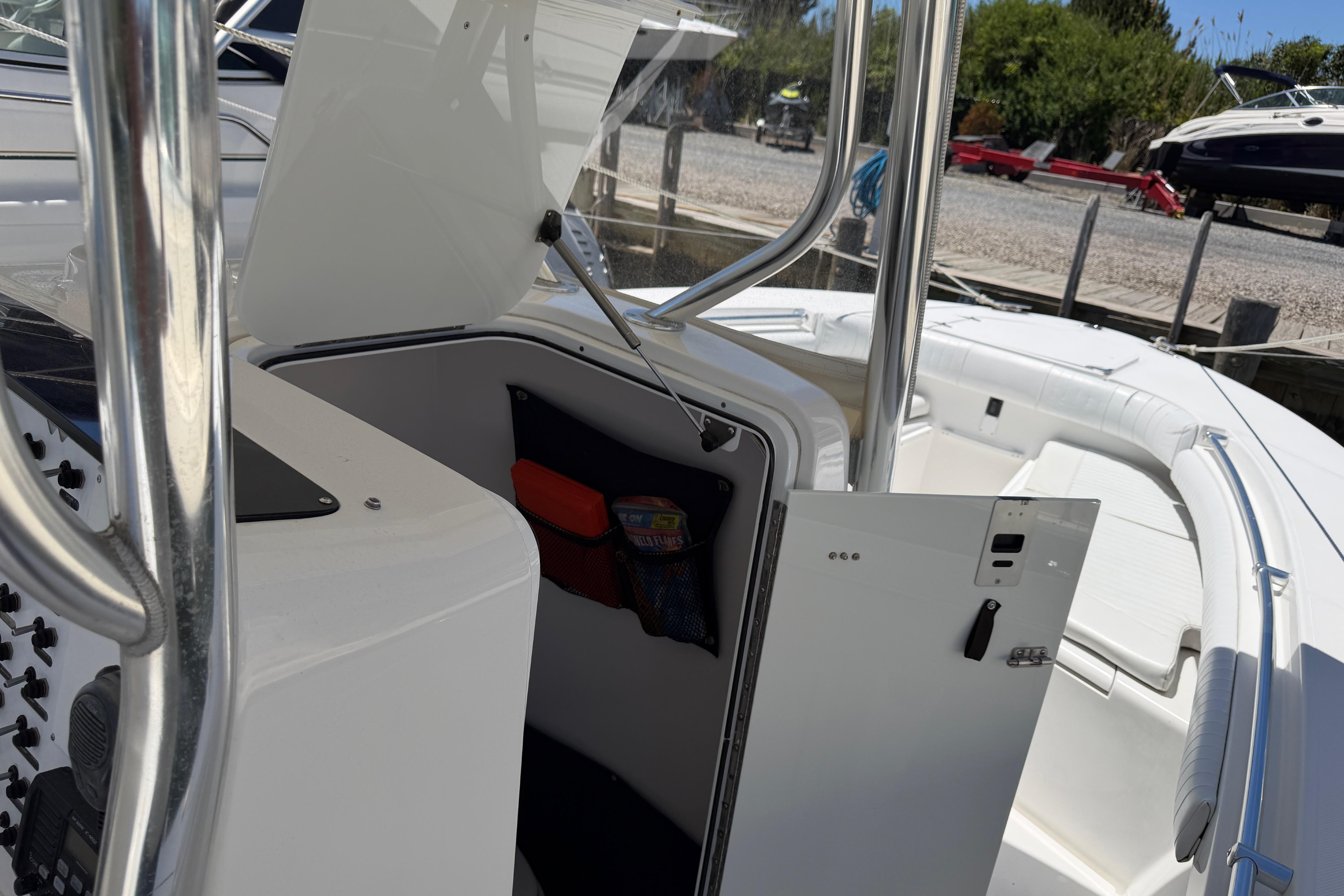 2006 Southport 26 Center Console boat interior with open storage compartment and seating area.
