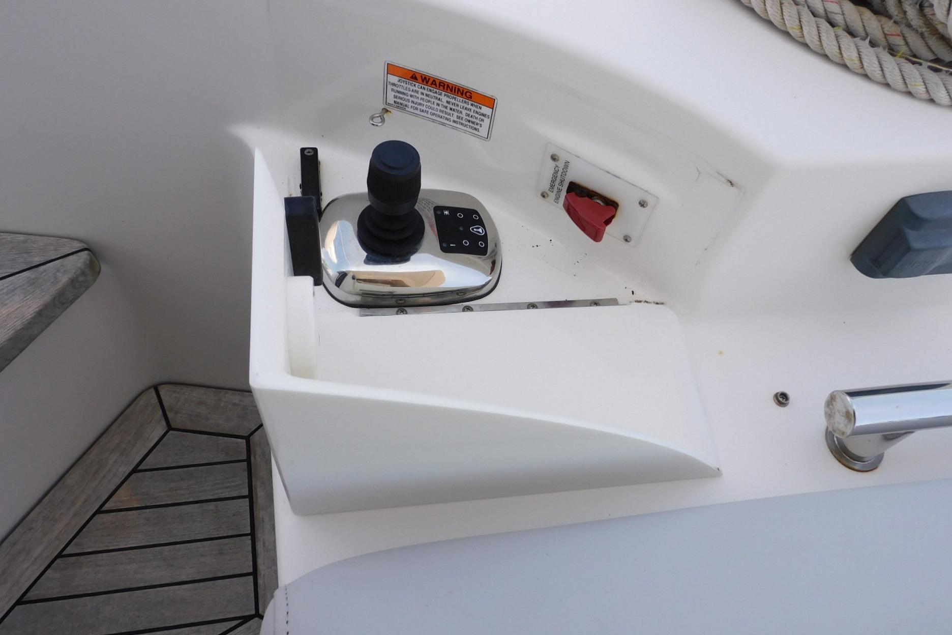 Control panel of a 2019 Sea Ray L550 yacht with joystick and warning label.