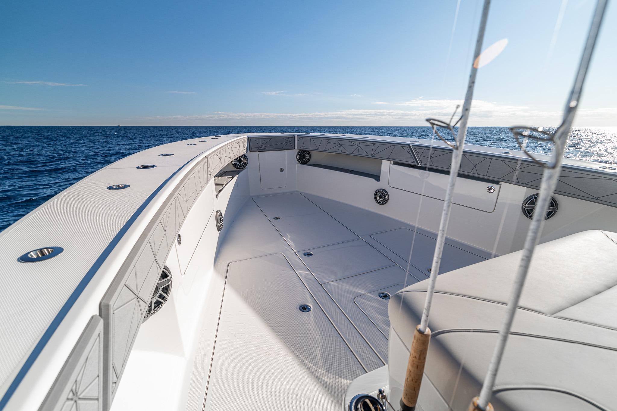 2026 SeaVee 420Z boat deck with fishing rods, ocean view, and clear sky.