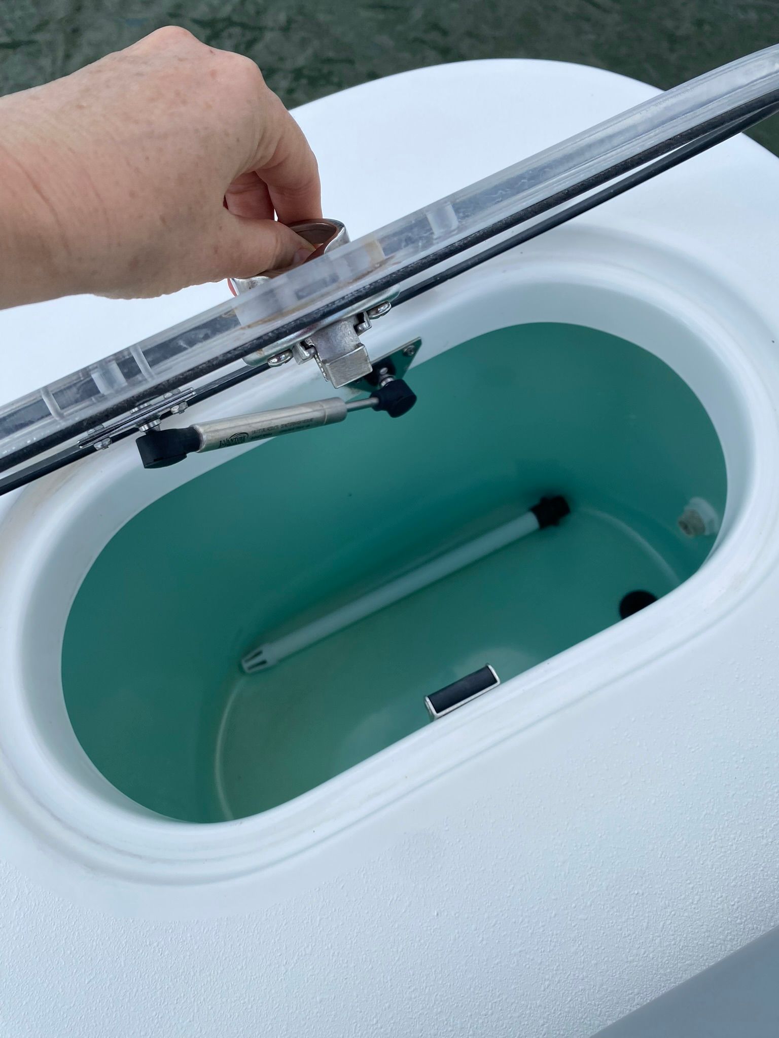 NauticStar Legacy 2021 boat, open storage compartment lid.