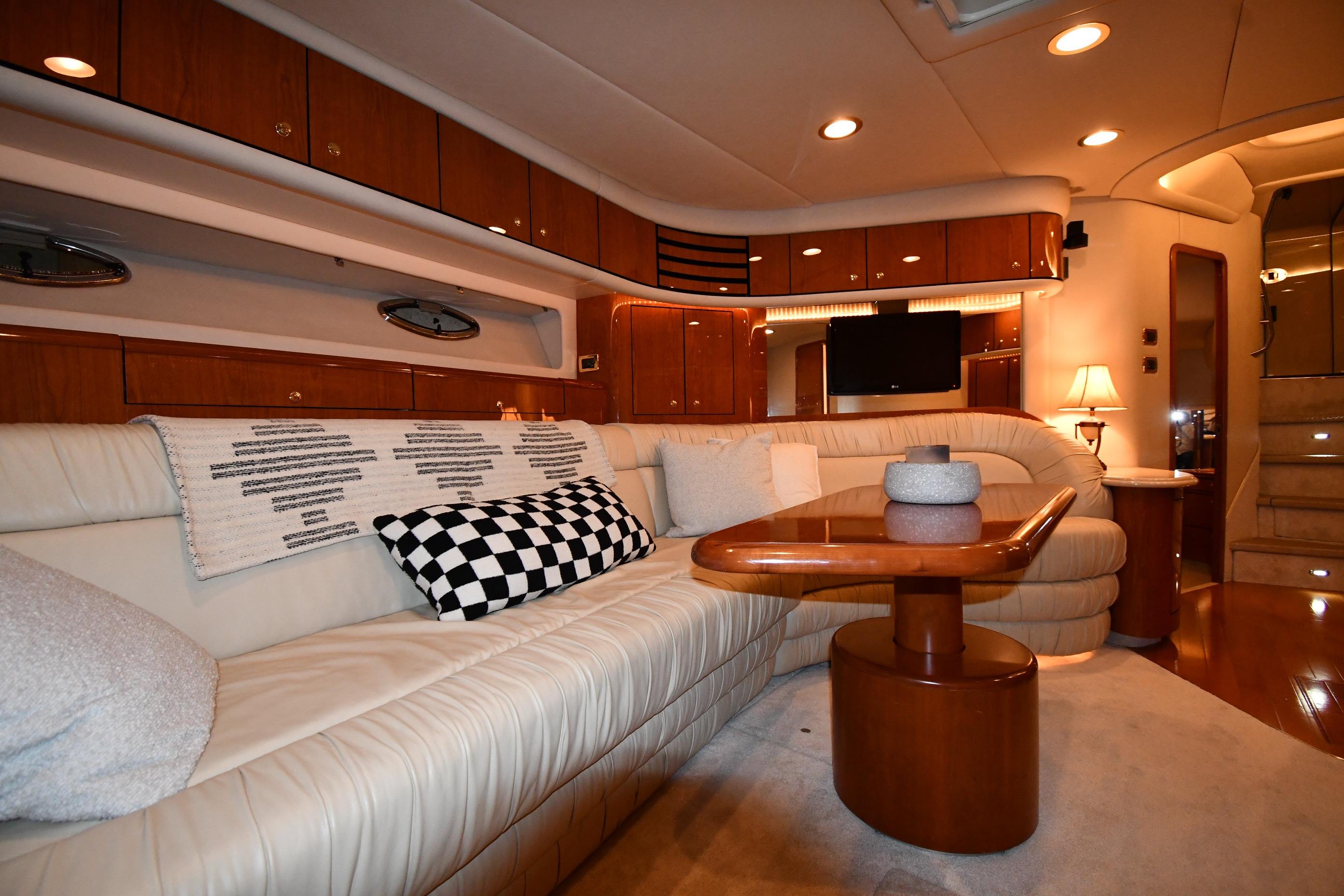 Luxurious interior of 2001 Sea Ray 540 Sundancer yacht with elegant seating and wooden accents.
