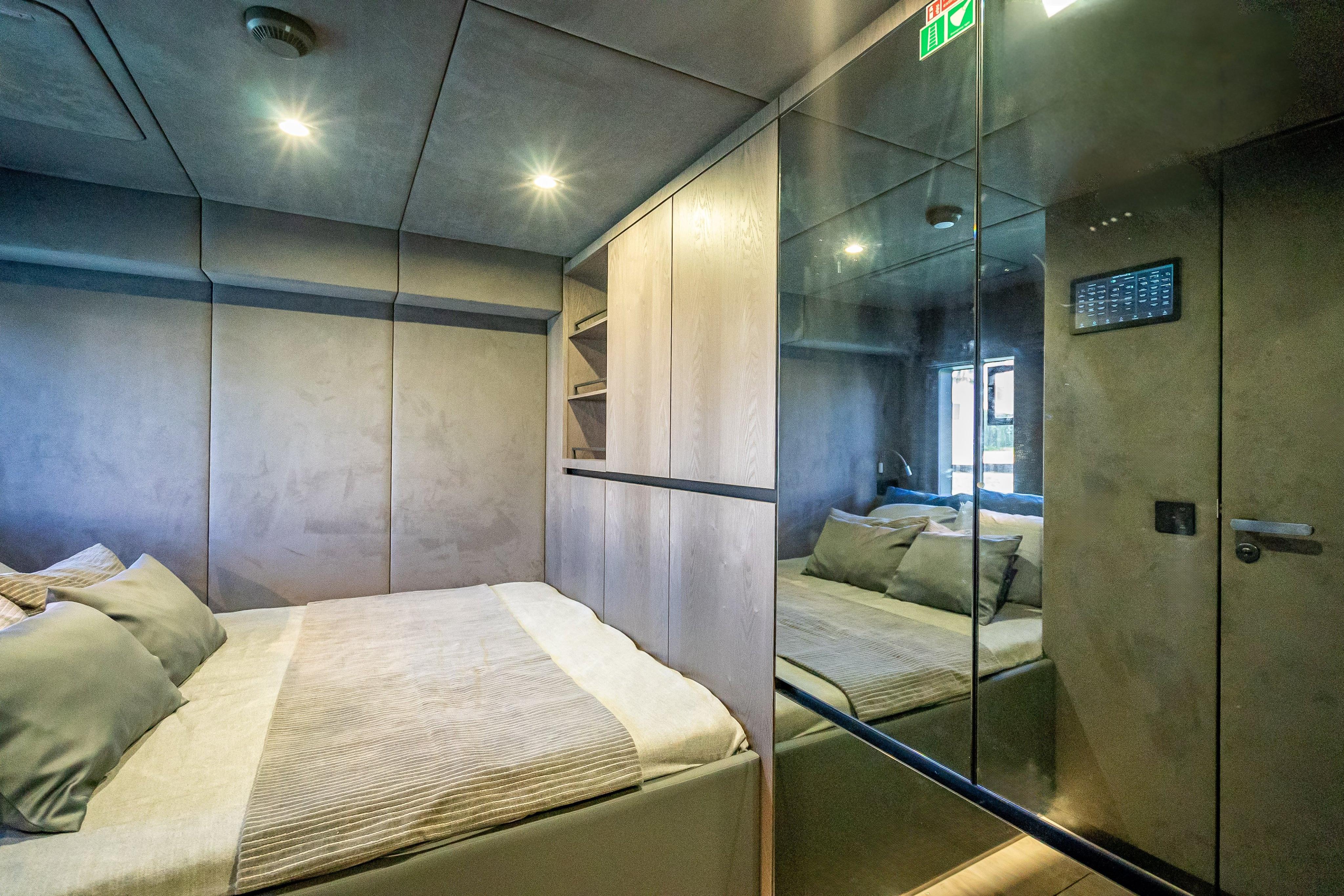 Luxurious bedroom interior of 2026 Sunreef 60 Power yacht with modern design and ambient lighting.
