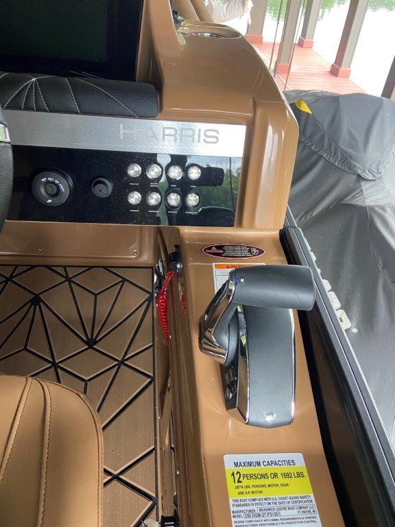 Control panel of 2023 Harris FloteBote 250 Grand Mariner boat with seating and throttle.