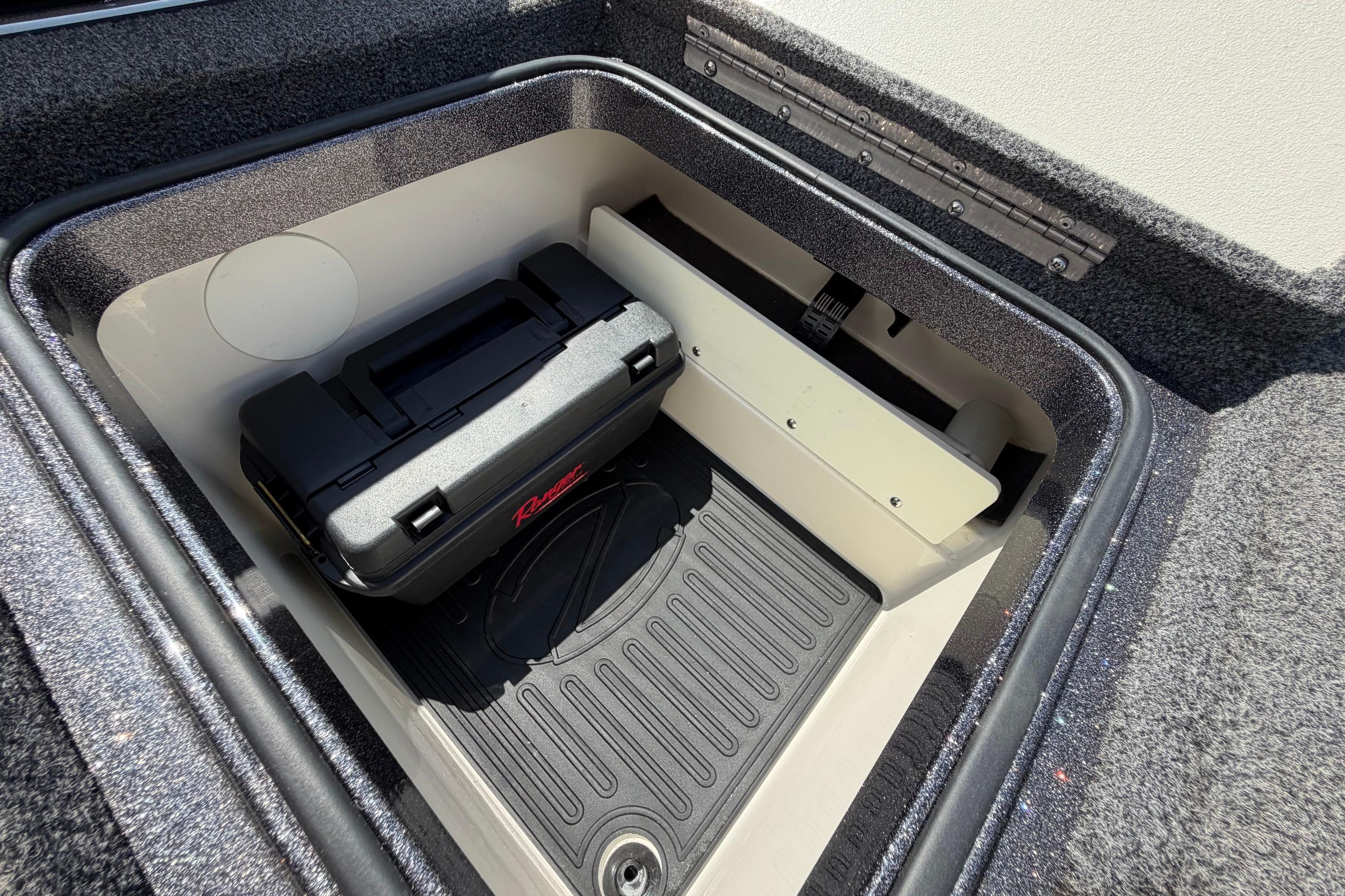 Storage compartment of a 2020 Ranger Z520L boat with a black toolbox inside.