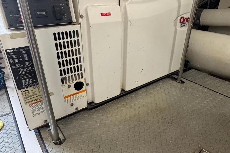 Onan generator in 2004 Lazzara SC Motor Yacht engine room, featuring metal flooring.