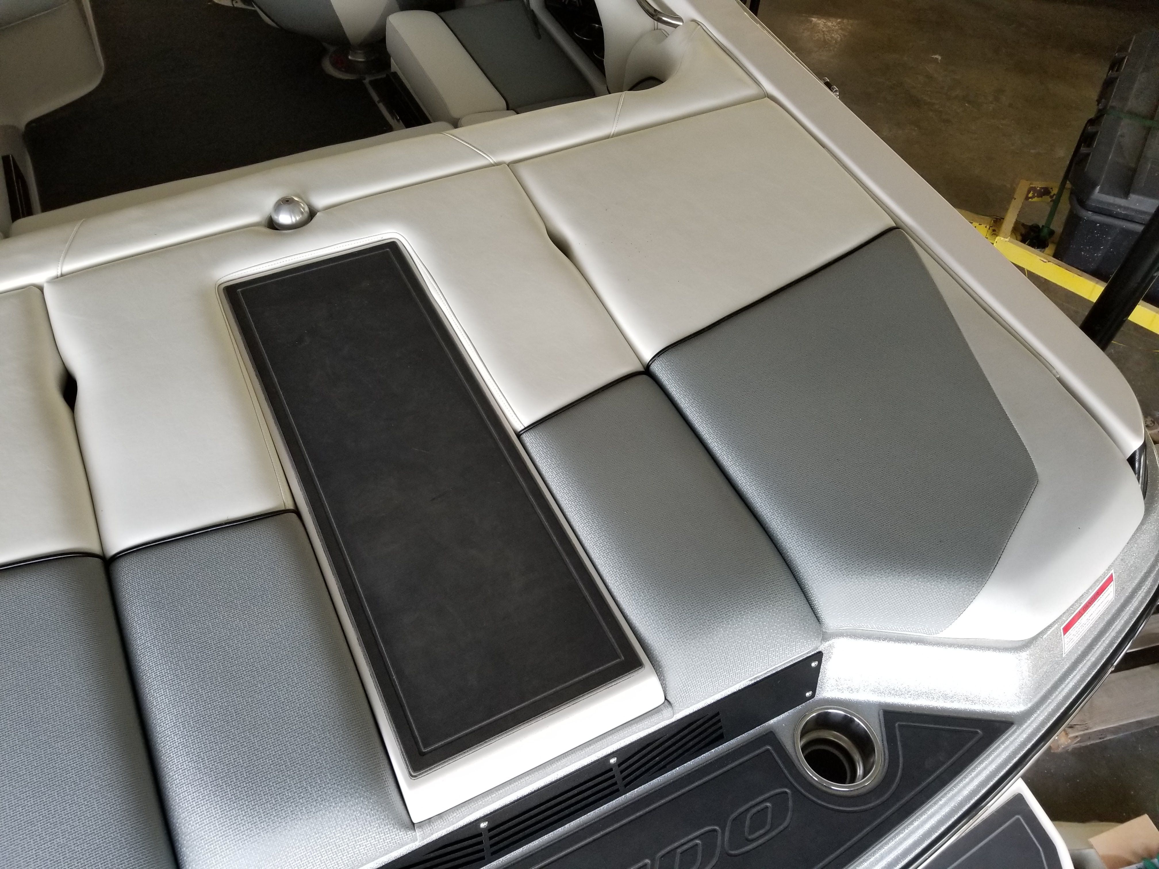 The image shows the rear of a Moomba Mondo boat with gray upholstery.