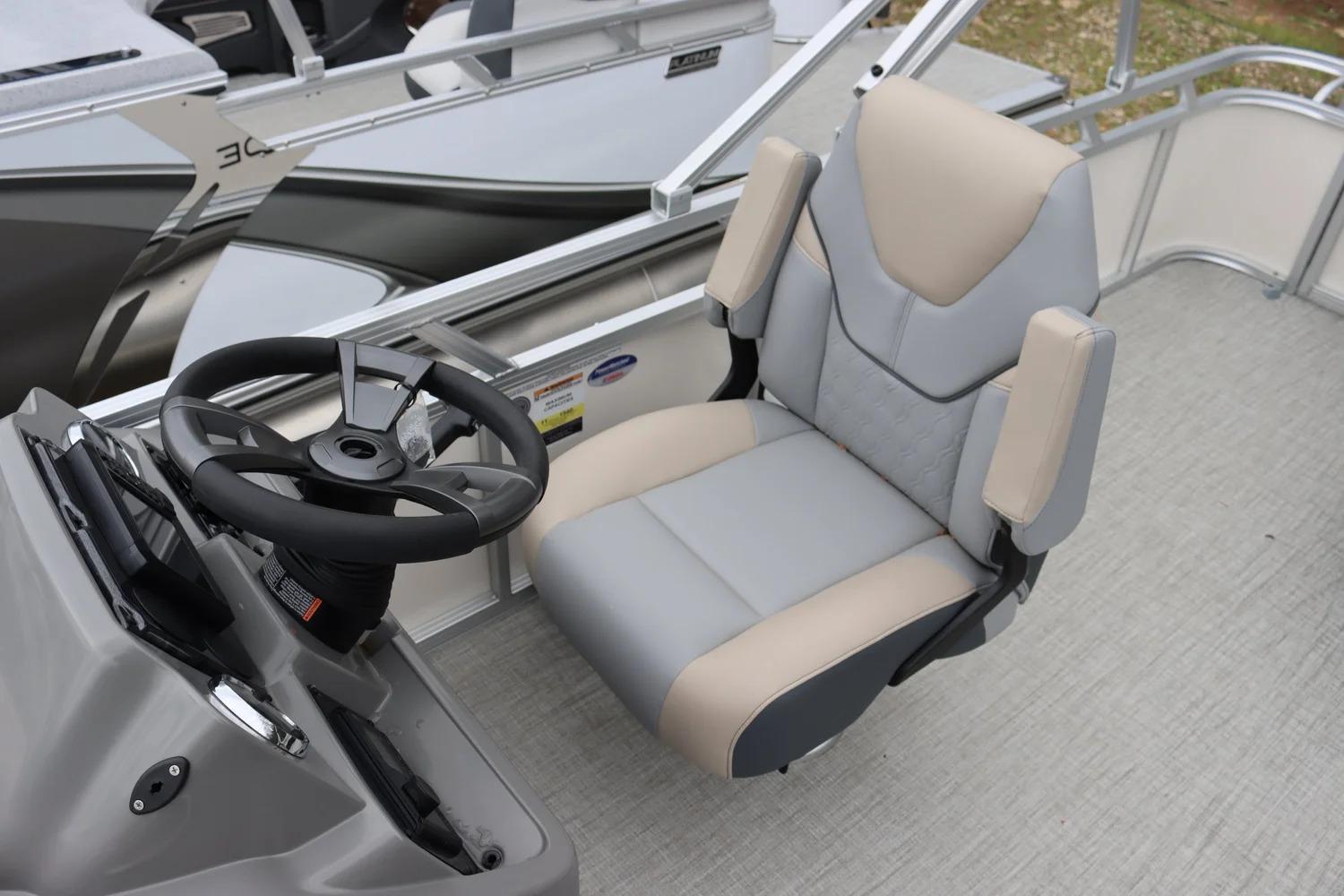 Captain's chair and steering wheel of 2025 Tahoe Pontoon Sport 85 Cruise boat.