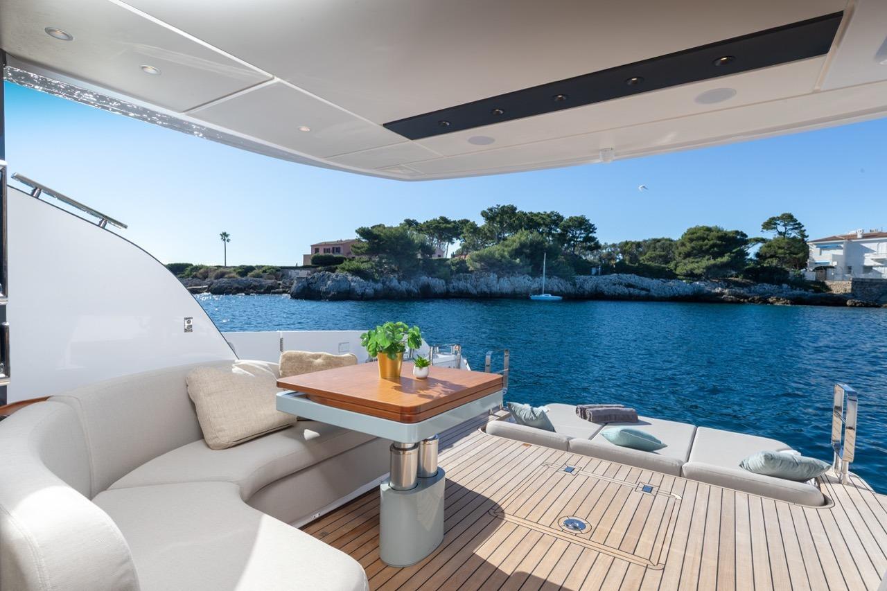 Luxurious 2025 Azimut Fly 62 yacht deck with elegant seating and scenic ocean view.