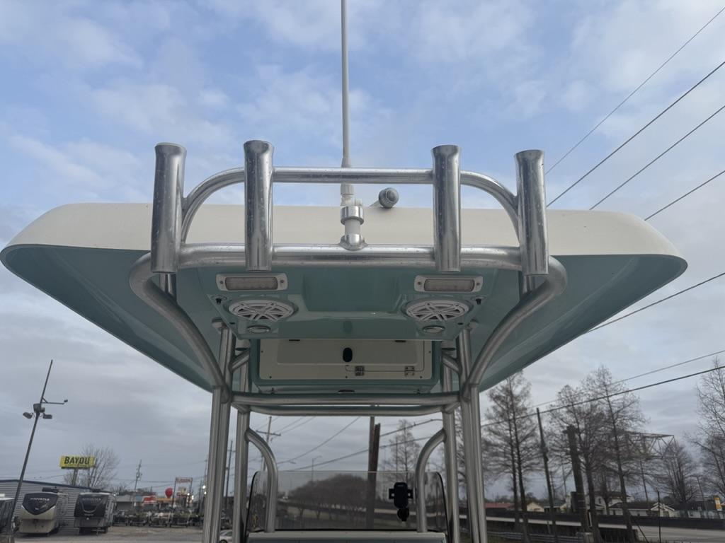 2017 ShearWater 270 Carolina Flare boat with T-top and rod holders, under a cloudy sky.