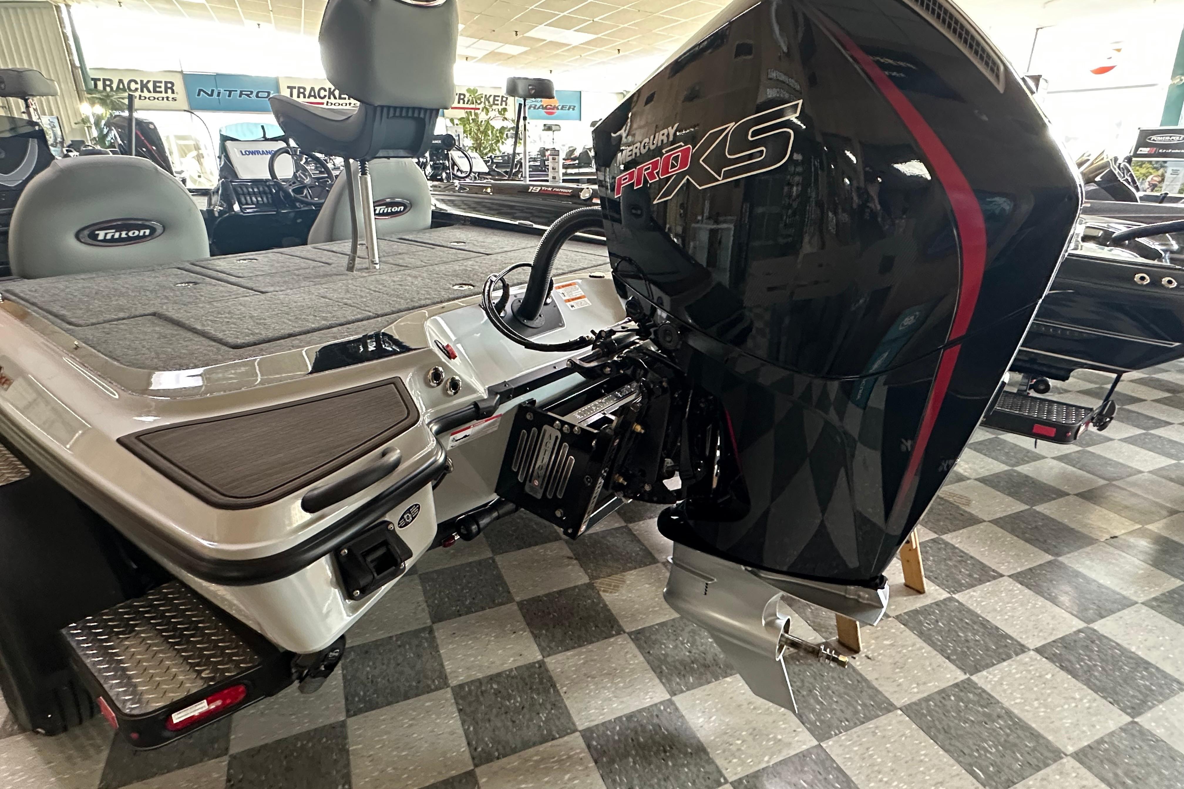 2024 Triton 20XP Patriot boat with Mercury Pro XS engine in showroom.