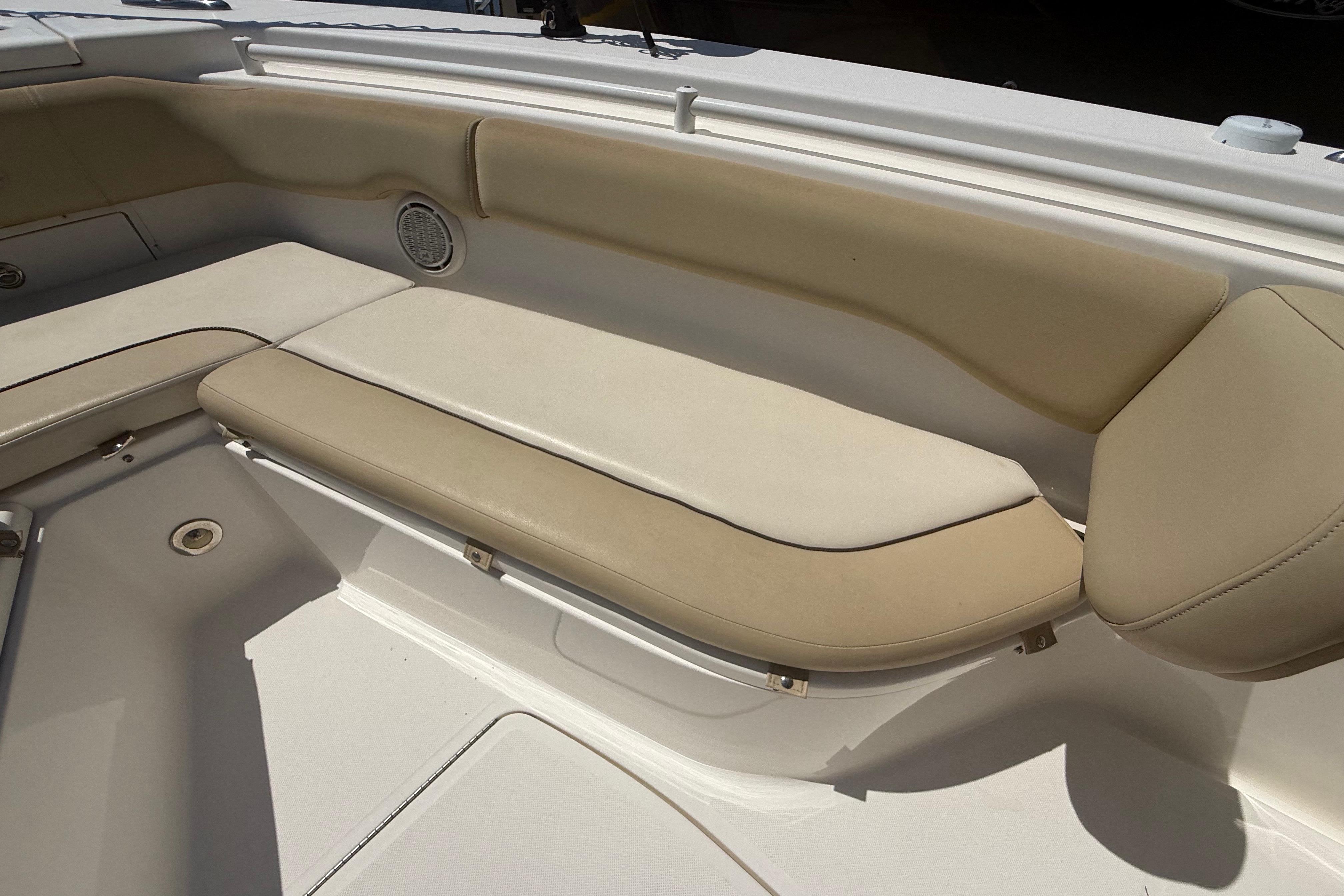 2019 Key West Billistic 281 Center Console boat seating area with beige cushions.
