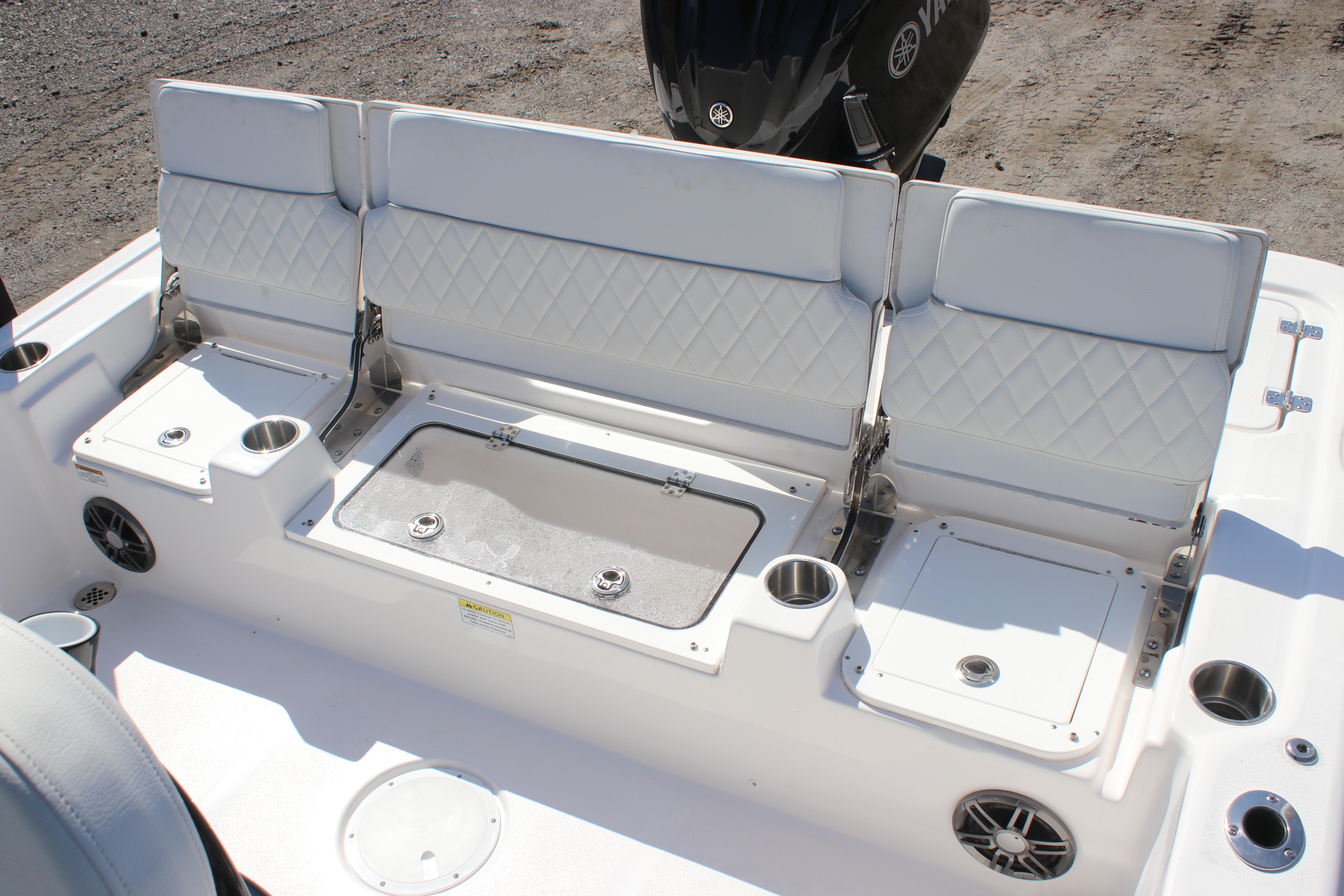 2025 Sea Fox 251 Bay Fox boat seating area with storage and cup holders.