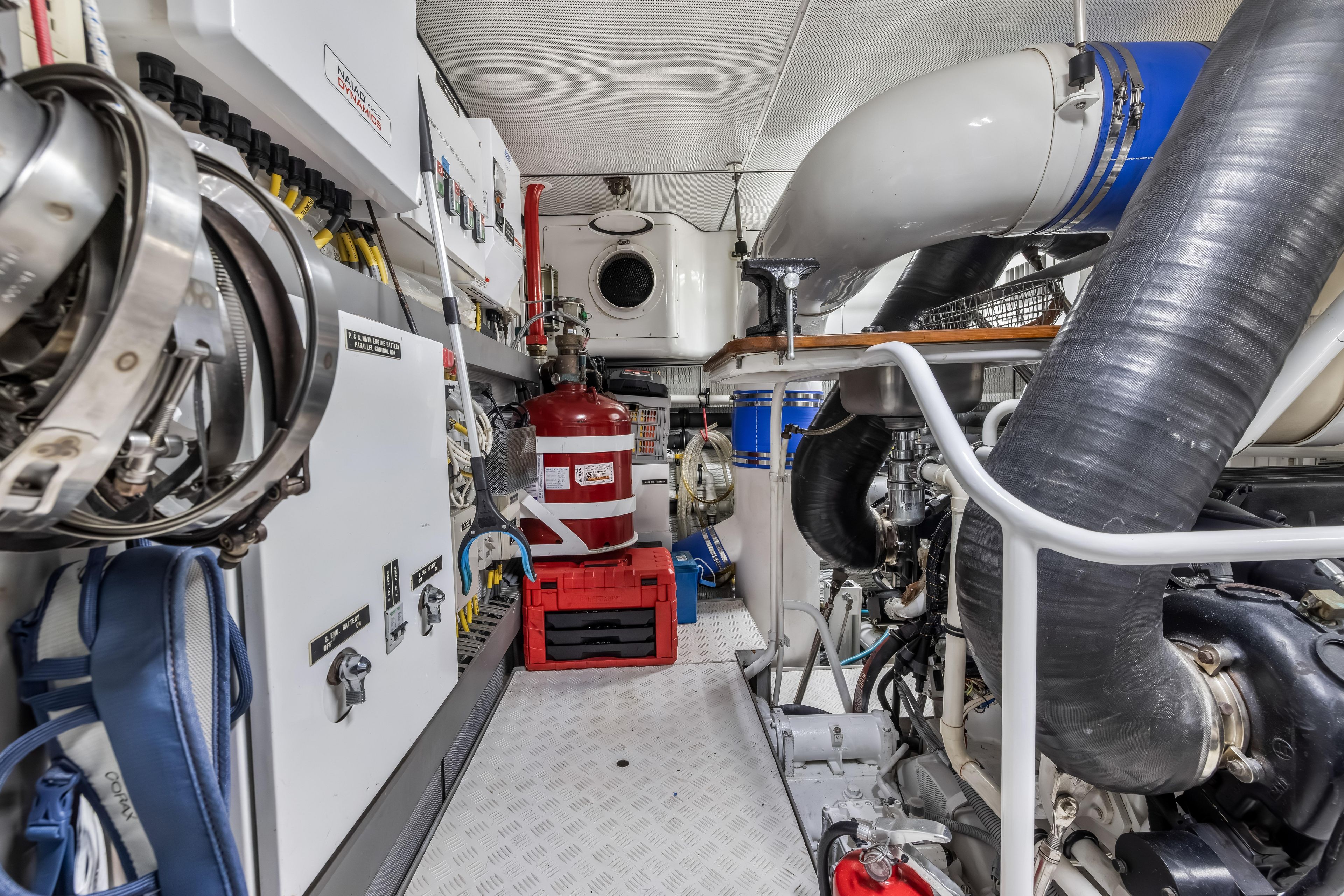 Engine room of 2012 Cheoy Lee 84 Bravo yacht with equipment and machinery.