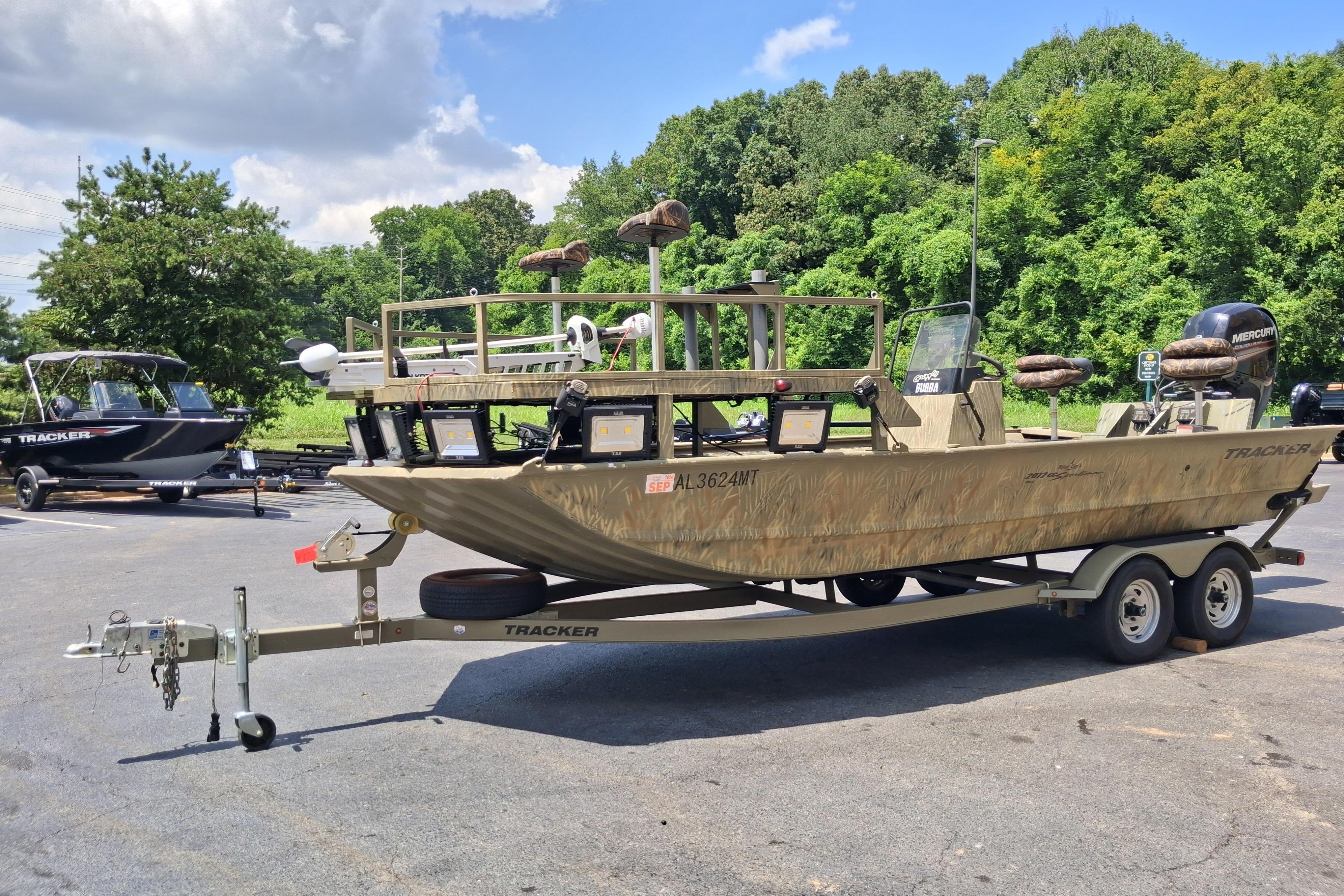 2016 Tracker Grizzly 2072 CC Sportsman boat on trailer, parked outdoors.