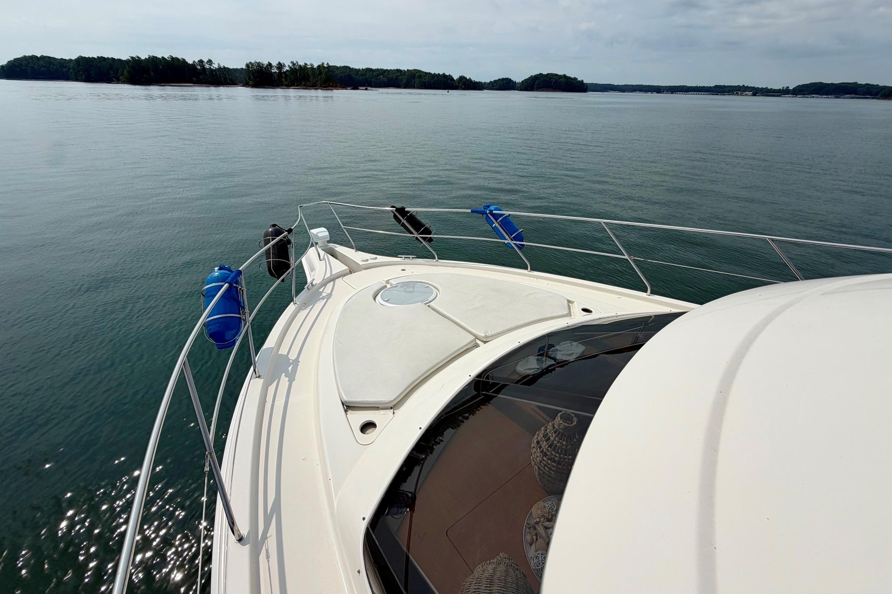 2004 Silverton 39 Motor Yacht cruising on a calm lake with scenic island views.