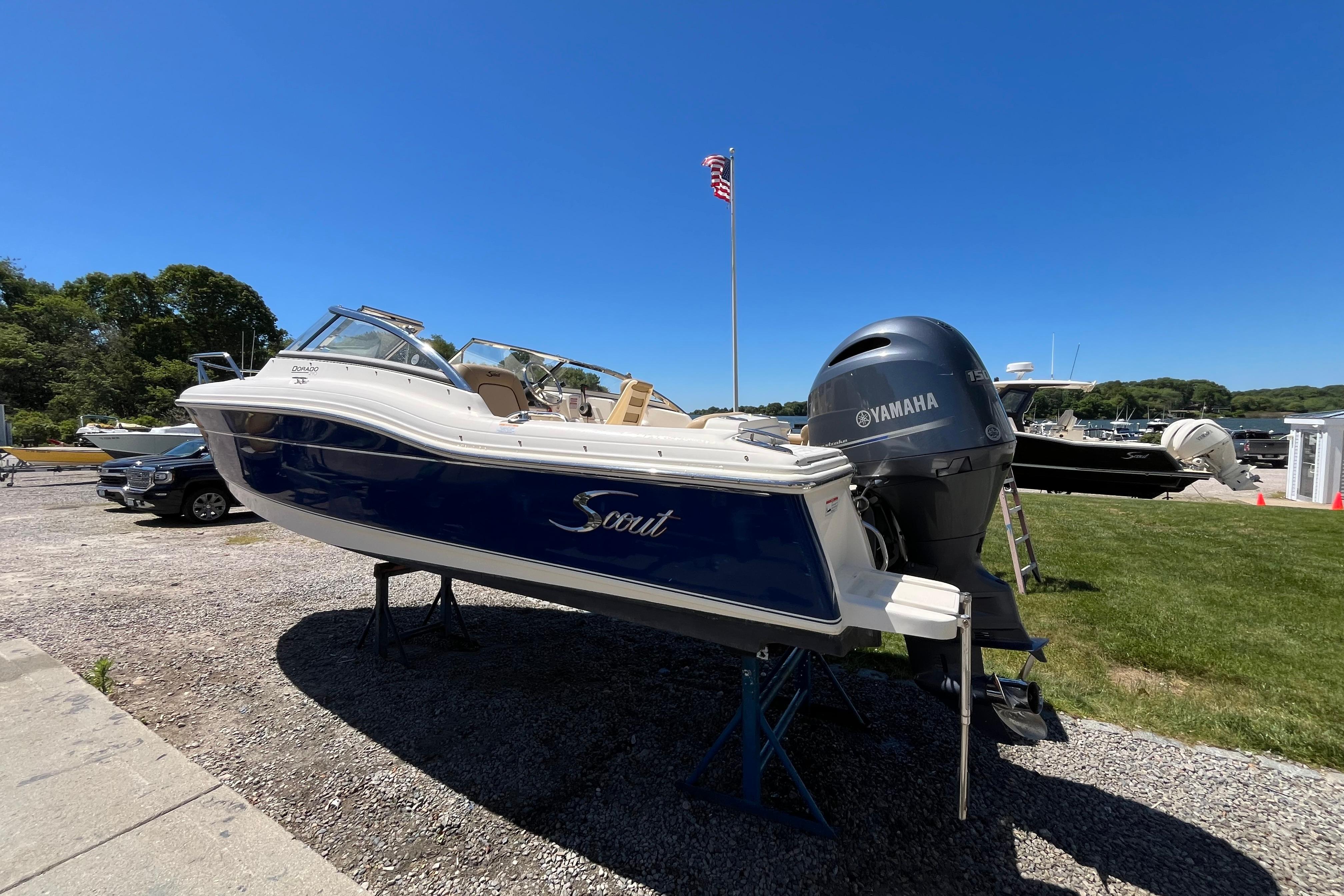 2017 Scout 210 Dorado boat with Yamaha engine on display outdoors.