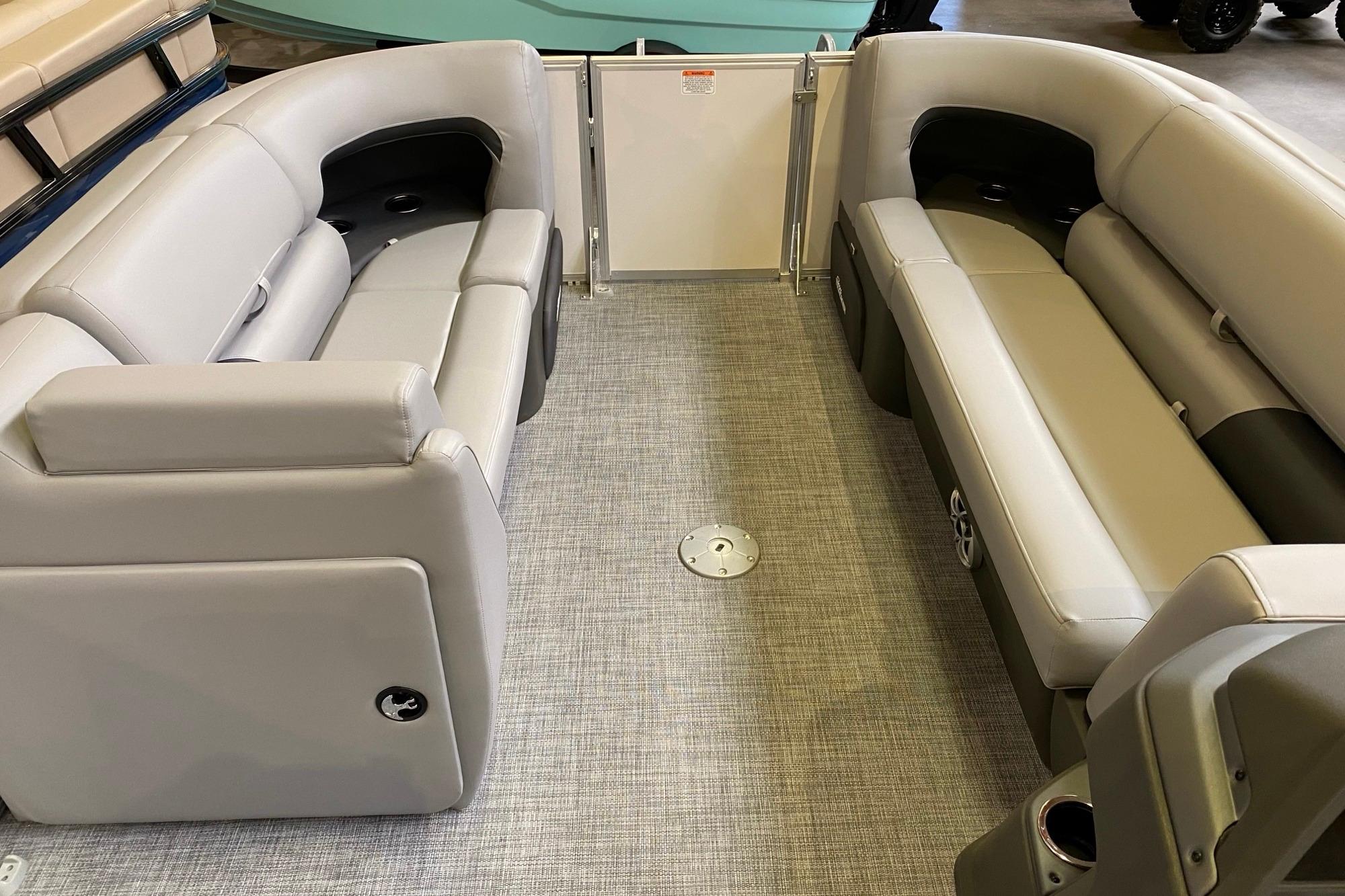 2026 Sun Tracker Party Barge 22 DLX interior with gray seating and spacious layout.