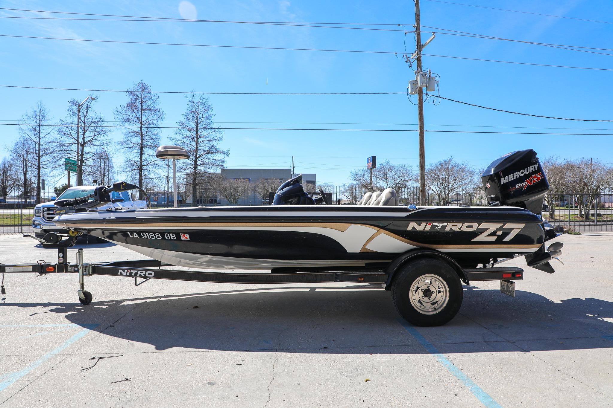 2013 Nitro Z-7 boat on trailer, parked outdoors under clear blue sky.