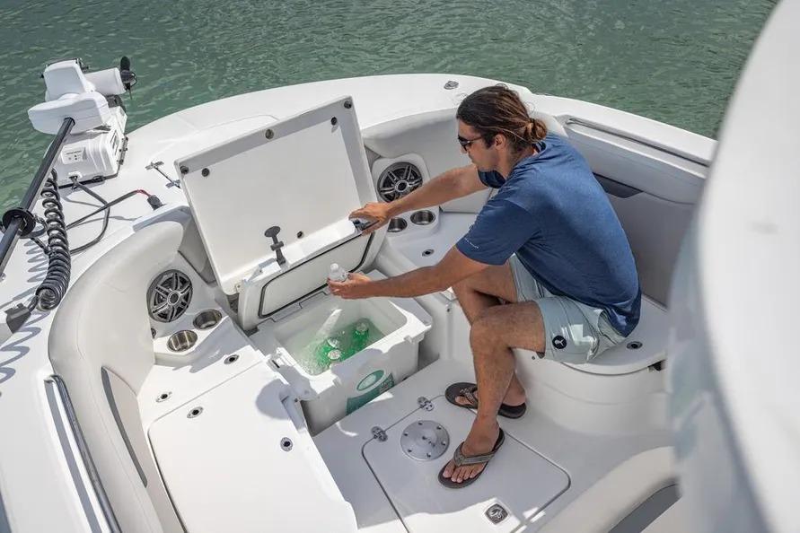 Man accessing cooler on 2025 Hurricane Center Console 24 OB boat.