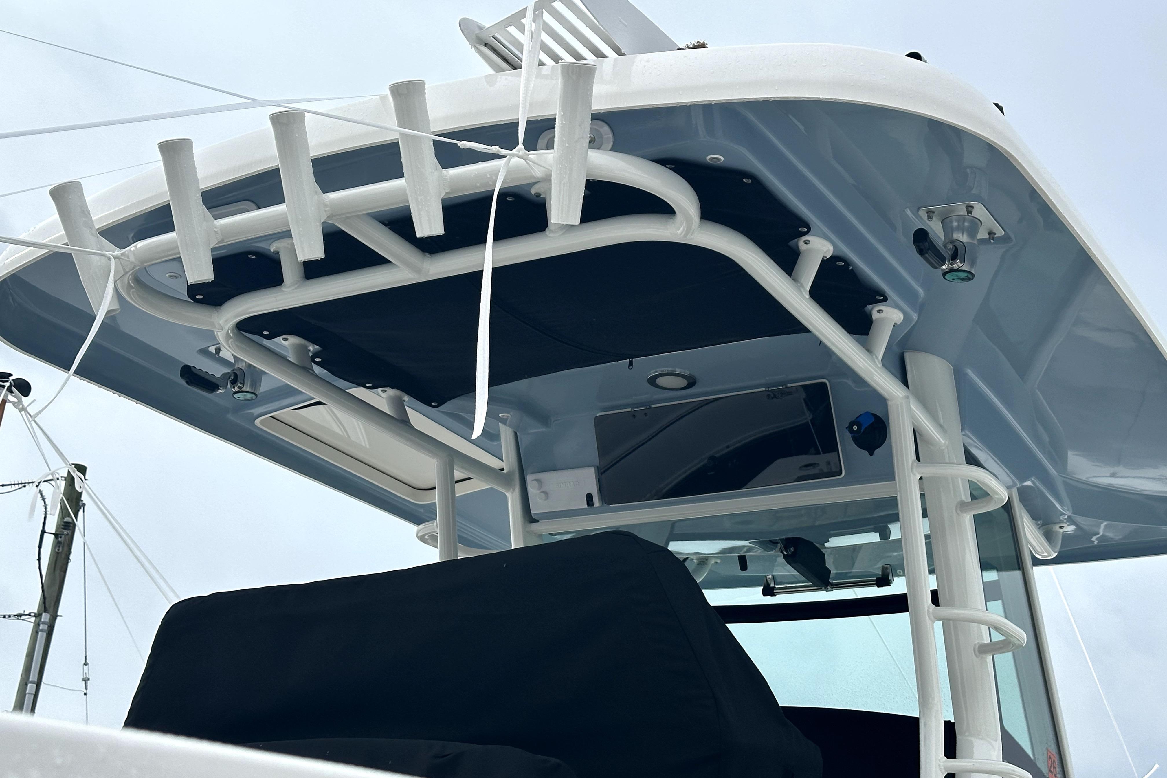 2023 Boston Whaler OUTRAGE boat with sturdy T-top and rod holders.