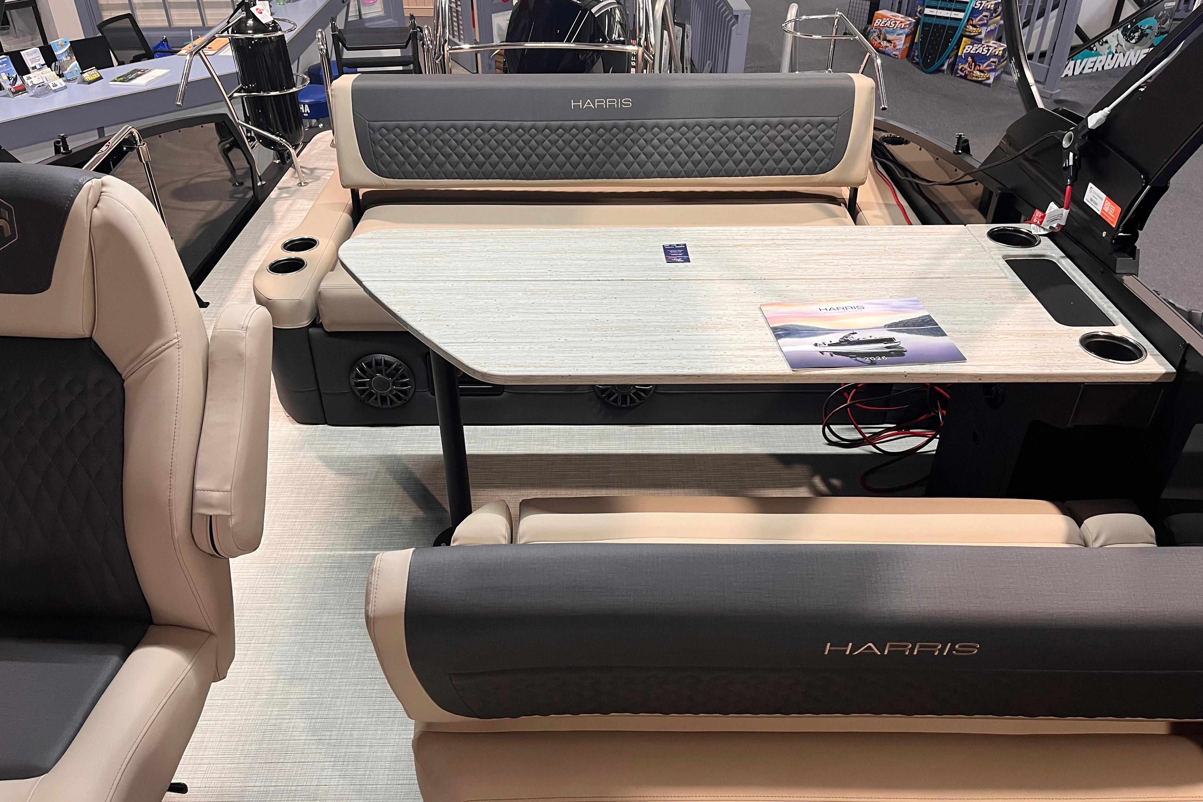 Luxurious interior of 2026 Harris Sunliner 250 pontoon boat with comfortable seating and table.