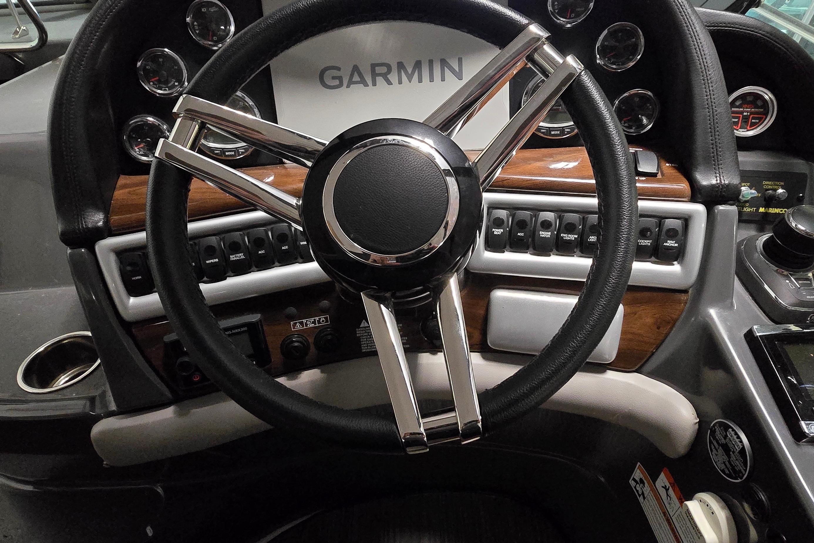 Steering wheel and dashboard of 2018 Four Winns V355 boat with Garmin navigation system.