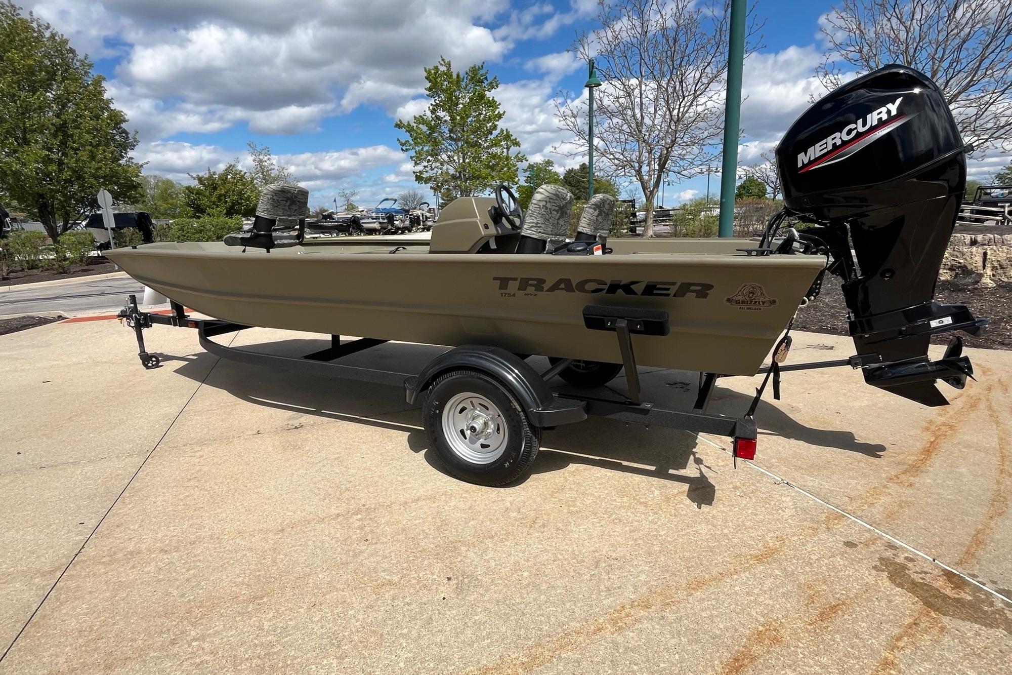 2026 Tracker Grizzly 1754 SC boat with Mercury engine on trailer, outdoors.
